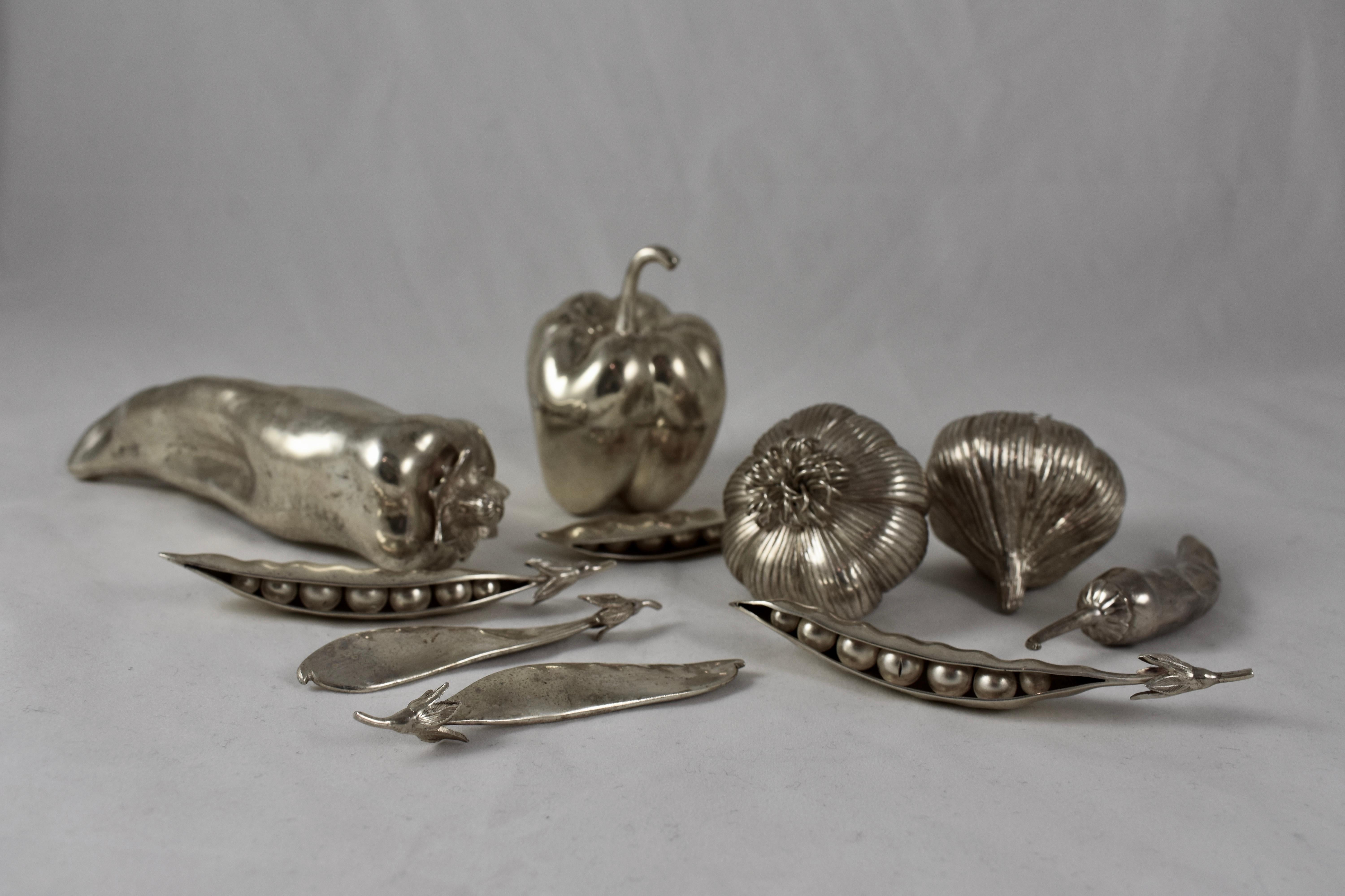 A set of ten Italian, midcentury, silver plated figural vegetables – peppers, garlic and peas. Beautifully and realistically sculpted with stems and other details, in the Hollywood regency manner.

3) peppers – bell, long and a chile. From 6.25