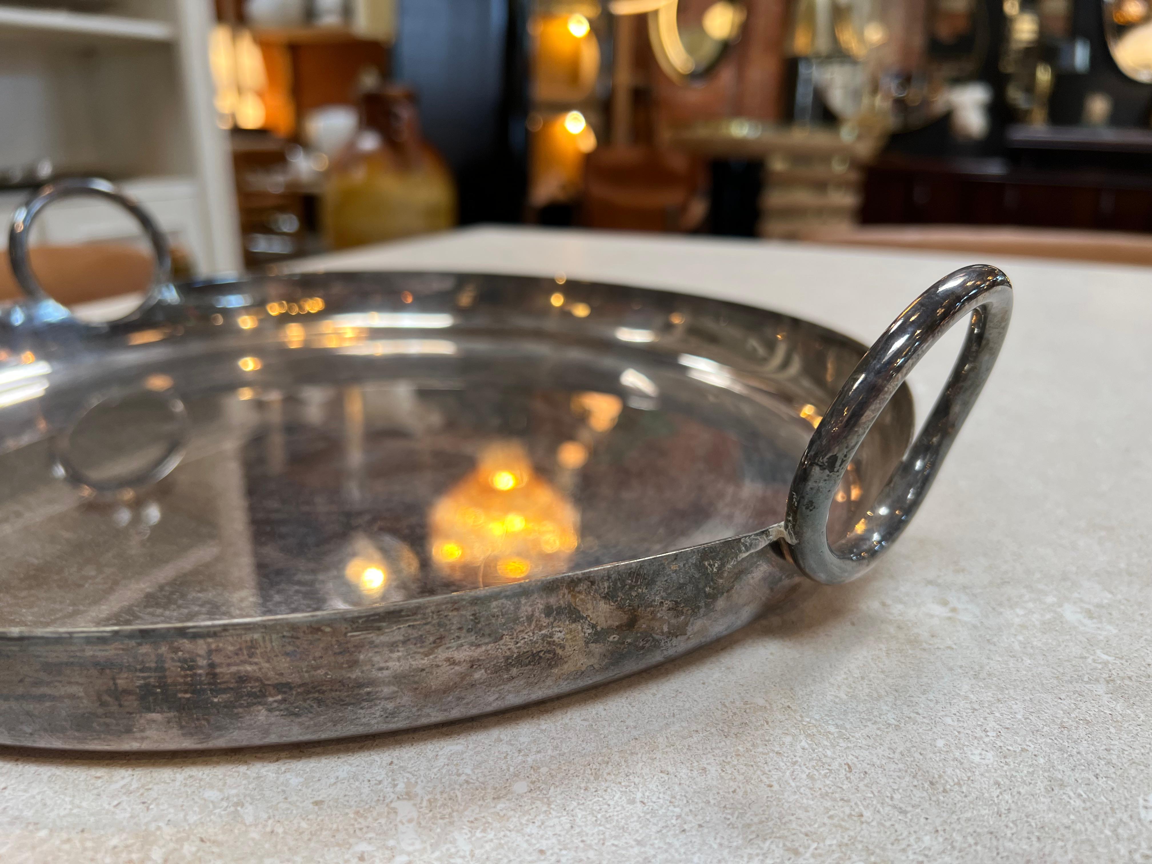 The Mid Century Italian Silver Plated Round Bowl from the 1970s exudes timeless elegance with its sleek design and lustrous silver-plated finish, representing the epitome of Italian craftsmanship during that era.

