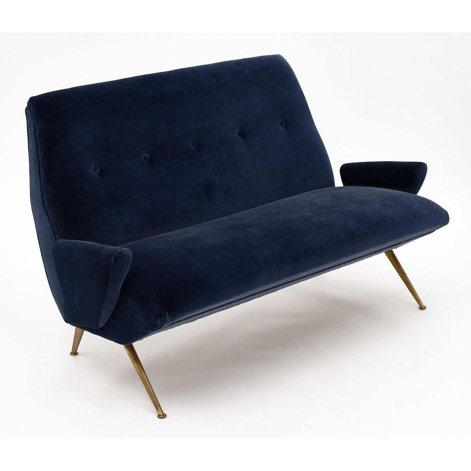 This Italian pair of armchairs and sofa was designed by Nino Zoncada in the 1950s. They have armrests and have been reupholstered in blue velvet. The body of the furniture is supported by brass legs. Both pieces of furniture are in relatively good,