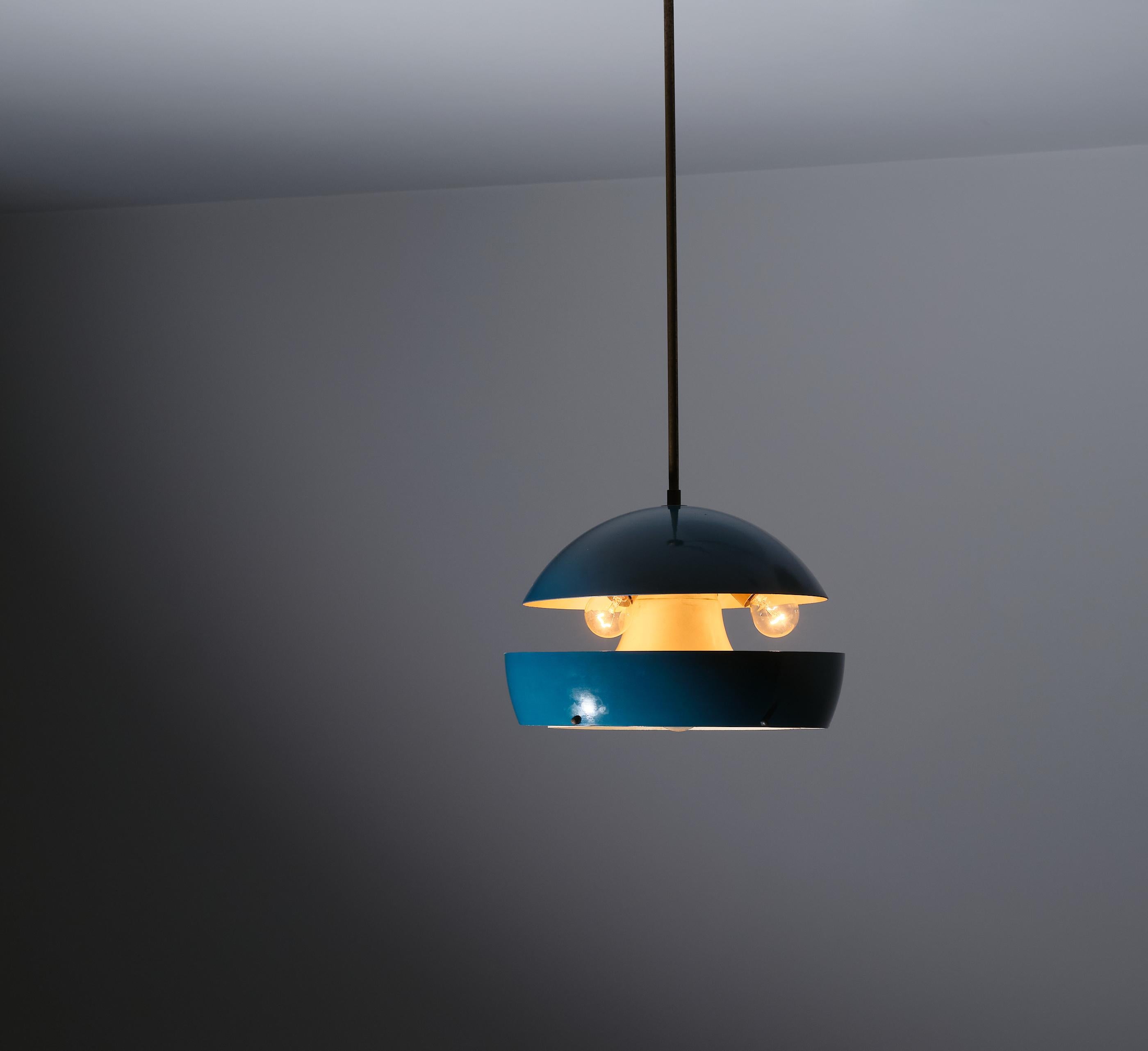 This Italian pendant lamp, crafted in the 1950s, exemplifies the elegant modern design of the mid-century era. The lamp features a charming spherical shape, constructed from brass and lacquered metal. The exterior is finished in a rich blue lacquer,