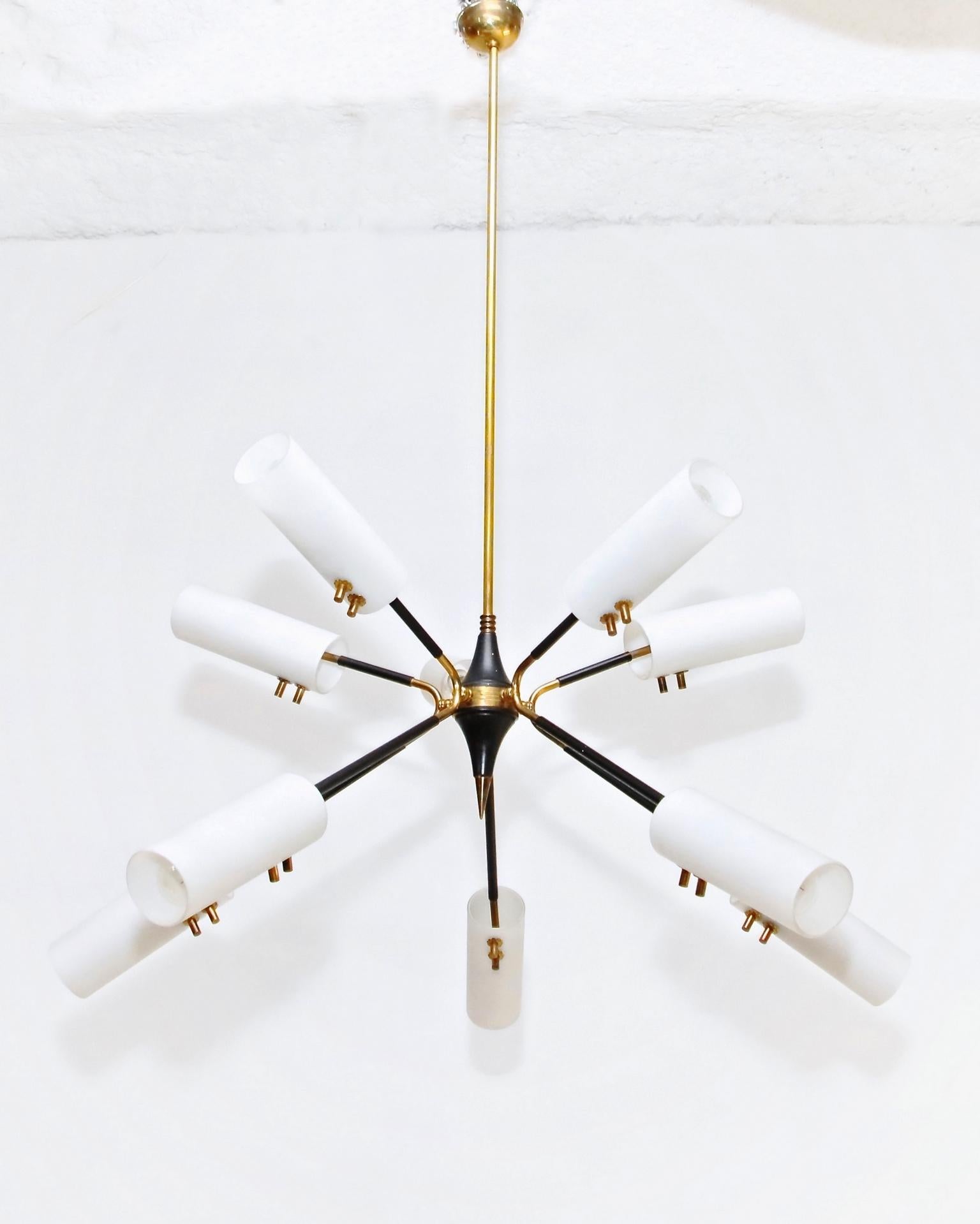 A 1950s chandelier sputnik style with a black powder coated structure, details in brass and lampshades in opaline glass. There is a total number of 10 lights in the lamp.