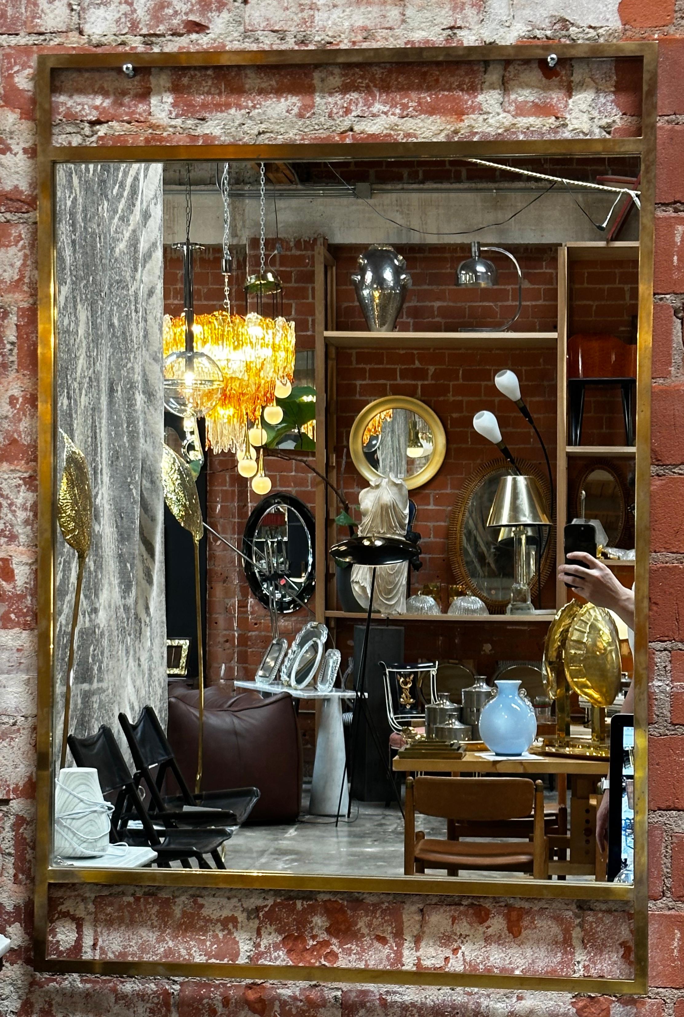 Vintage Italian oversize wall mirror with a brass frame and original patina.