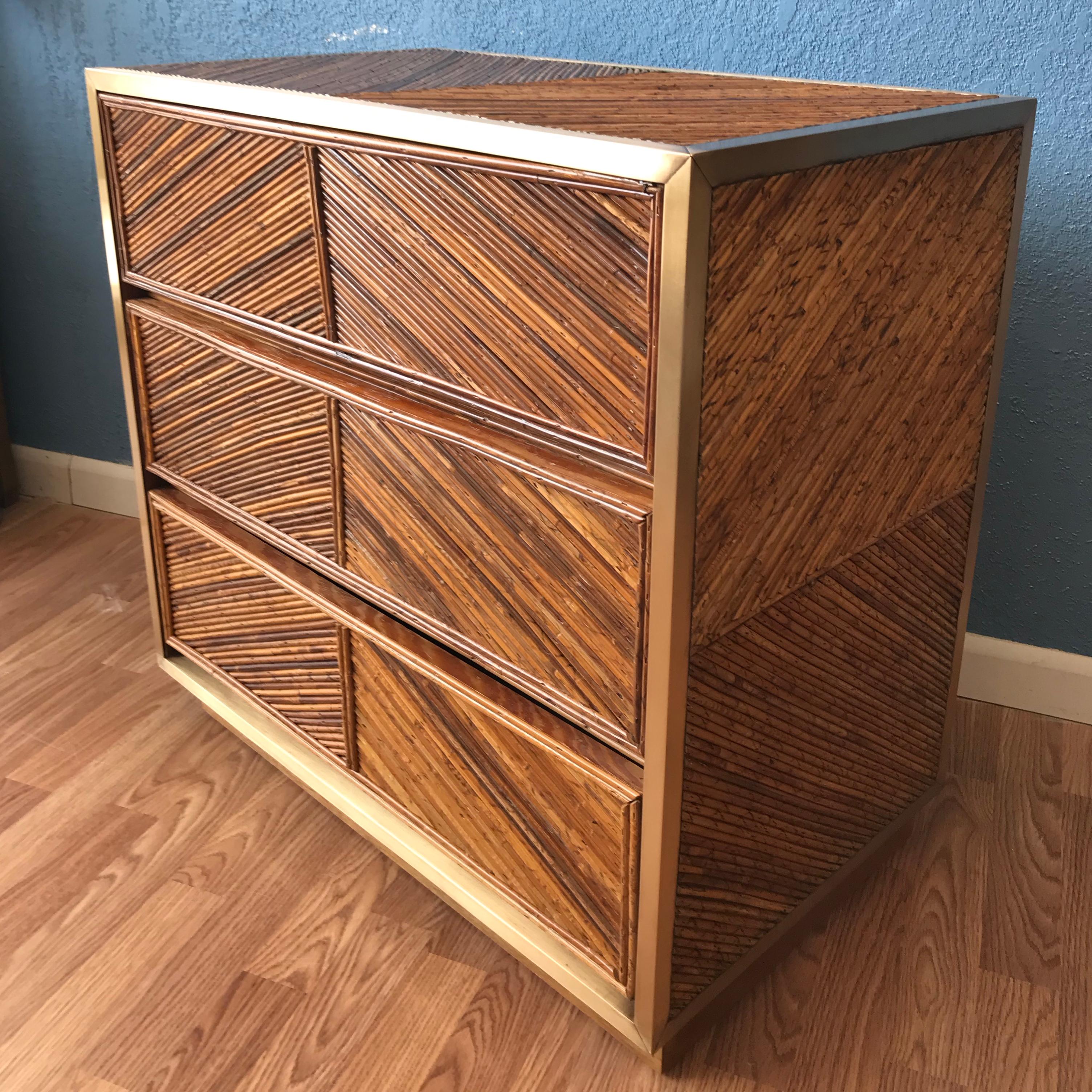 Sharp design: The dresser is beautifully finished on all four sides with extensive stick rattan
geometric inlays. It is appointed with brass accents. Nice size and form.