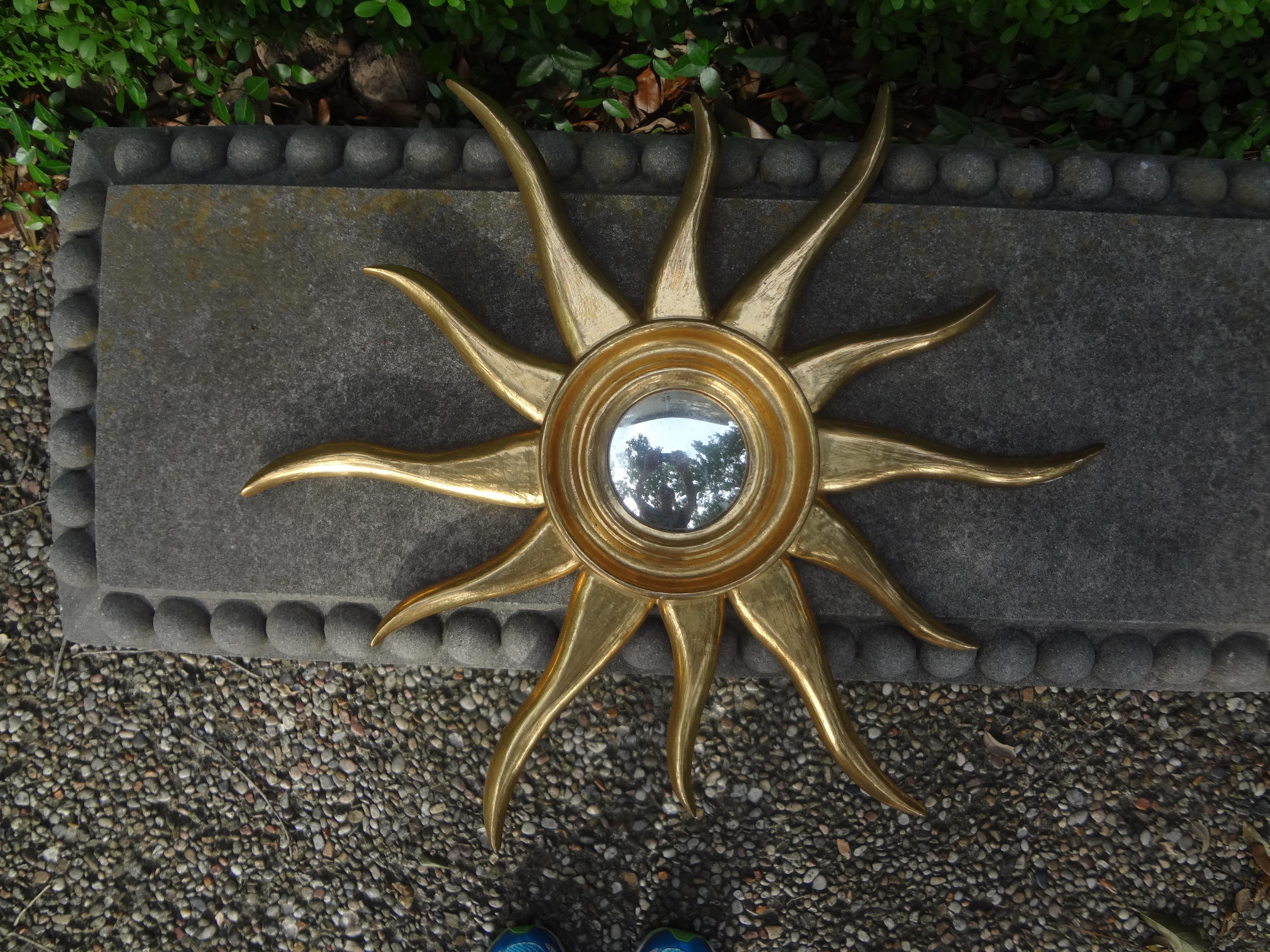 Stunning mid-century Italian sunburst convex mirror. This listing is for a beautiful vintage Italian water gilt sunburst mirror with a convex center. Overall dimensions-21 inches. Convex mirror center- 3.5 inches. Fabulous when displayed in a