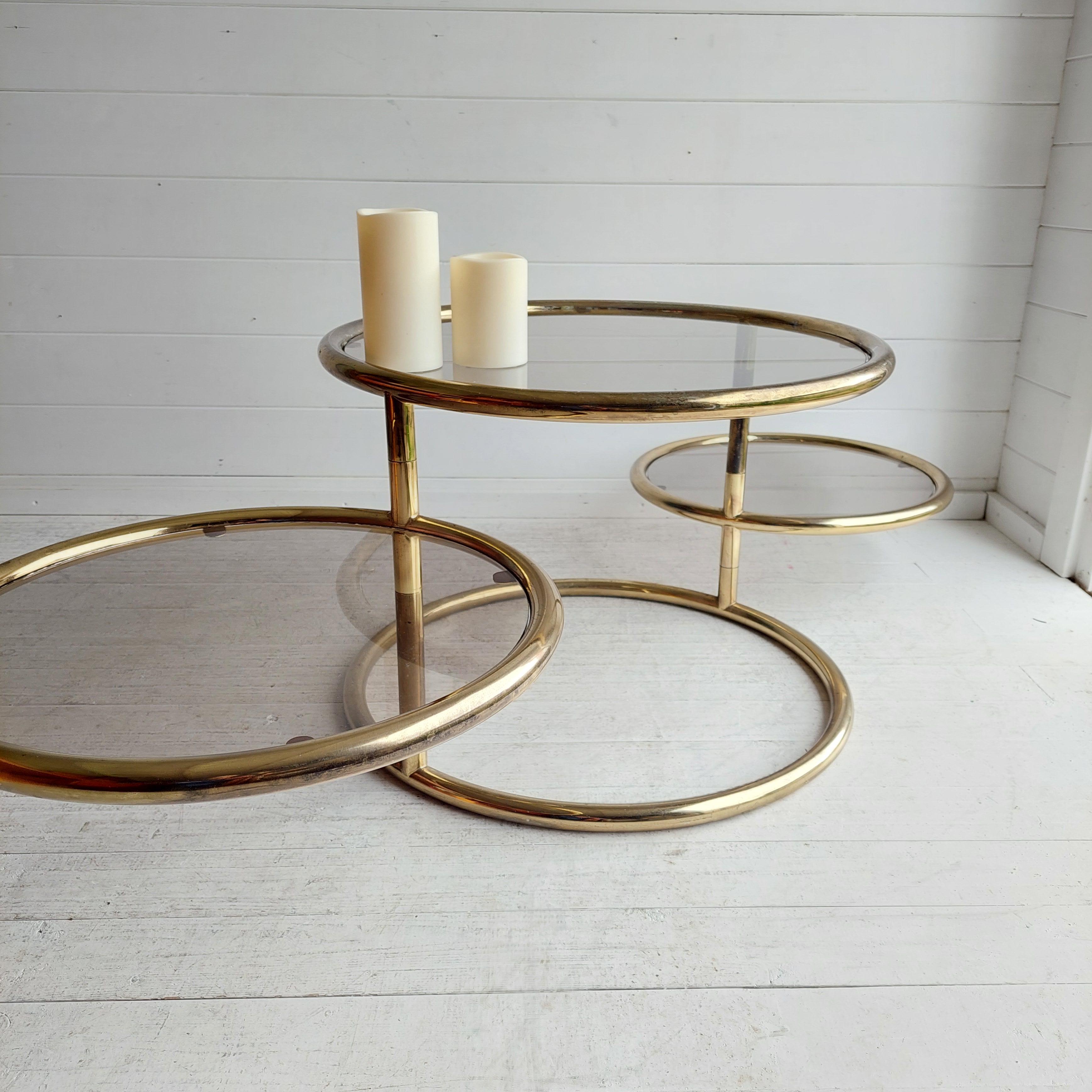 A vintage Milo Baughman style three-tier coffee table. 

In this listing you will find a stunning Mid Century Modern swivel coffee table that many attribute to Milo Baughman. 
It can function as a side table when closed or a coffee table when fully