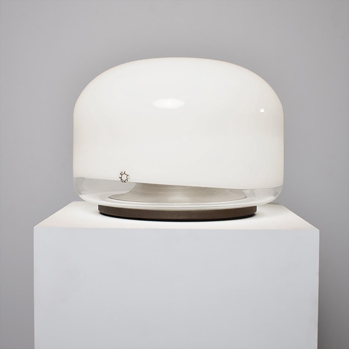 Beautiful and rare floor or table lamp model “Medusa” designed by Roberto Pamio for Leucos, Italy 1970. The lamp has a white and transparent blown glass shade which rests on an heavy iron base. It is a functional light source and staged addition as