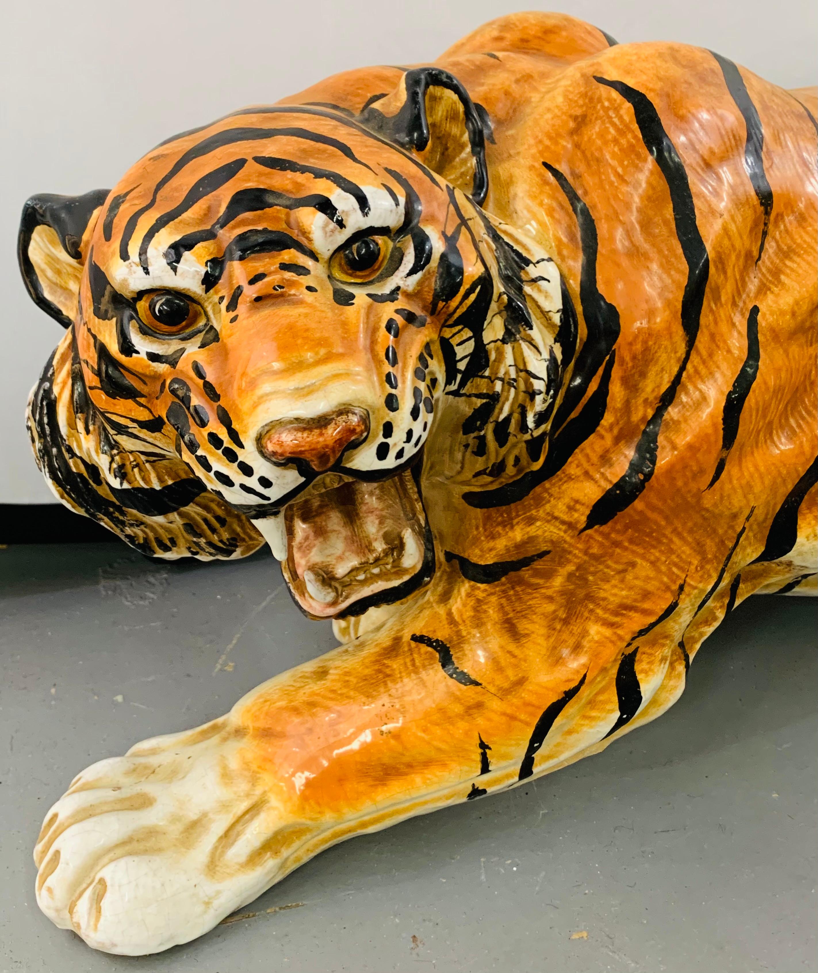 An amazing glazed Italian terracotta tiger statue or sculpture. The beautifully hand painted tiger is in a pouncing position and has a made of Italy stamps in the Botton of his feet. Made circa 1970s this powerful yet gorgeous tiger will make an