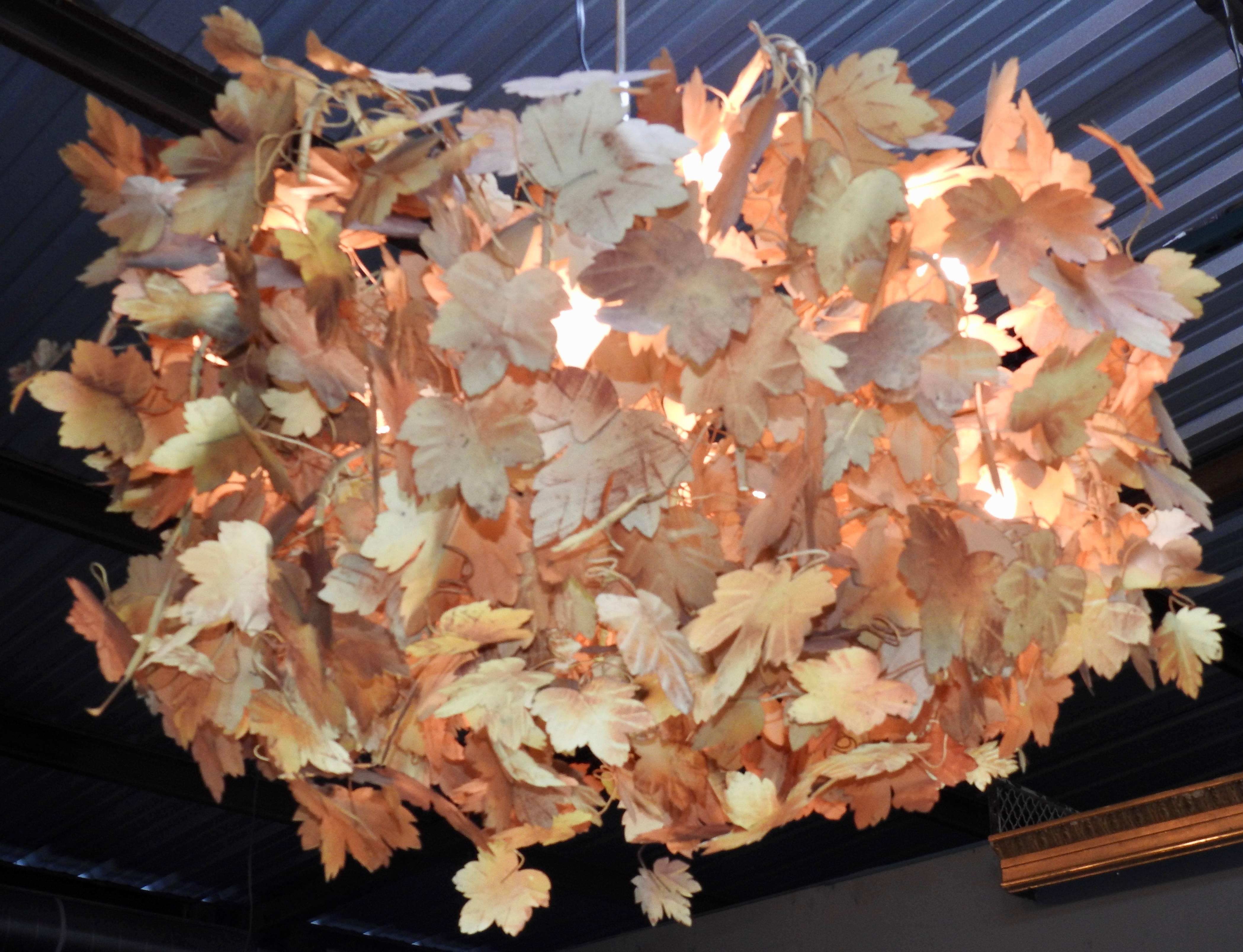 Multicolored leaves have been hand painted and adorn this tole chandelier from Italy. Each leaf has been handcrafted and attached to the fixture.