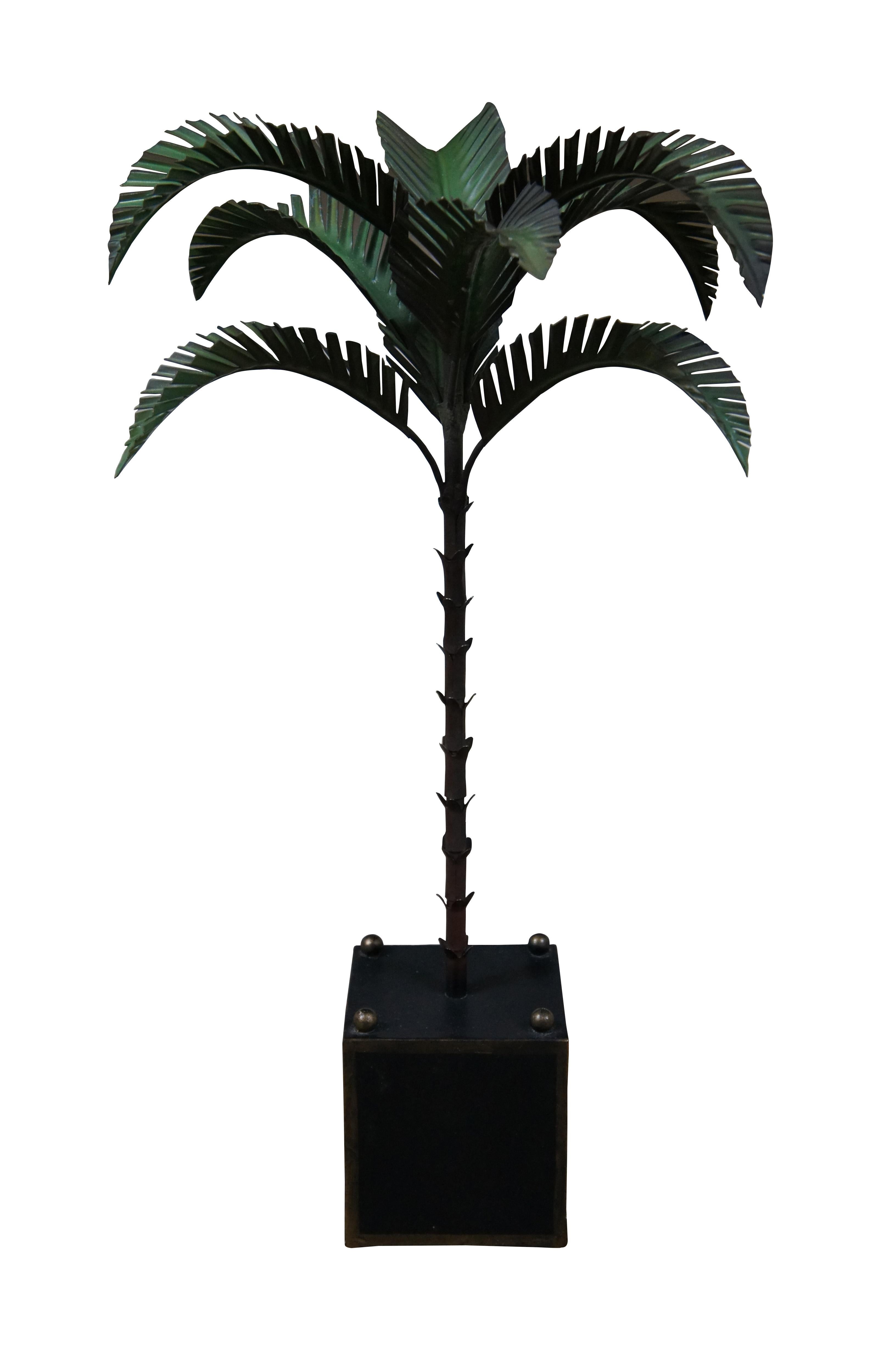Mid century 1960’s Italian toleware painted metal lamp or sculpture in the shape of a palm tree perched on a black and gold planter base with gold ball feet and finials. Numbered 1-2038, made in Italy. This was originally a lamp, but was converted