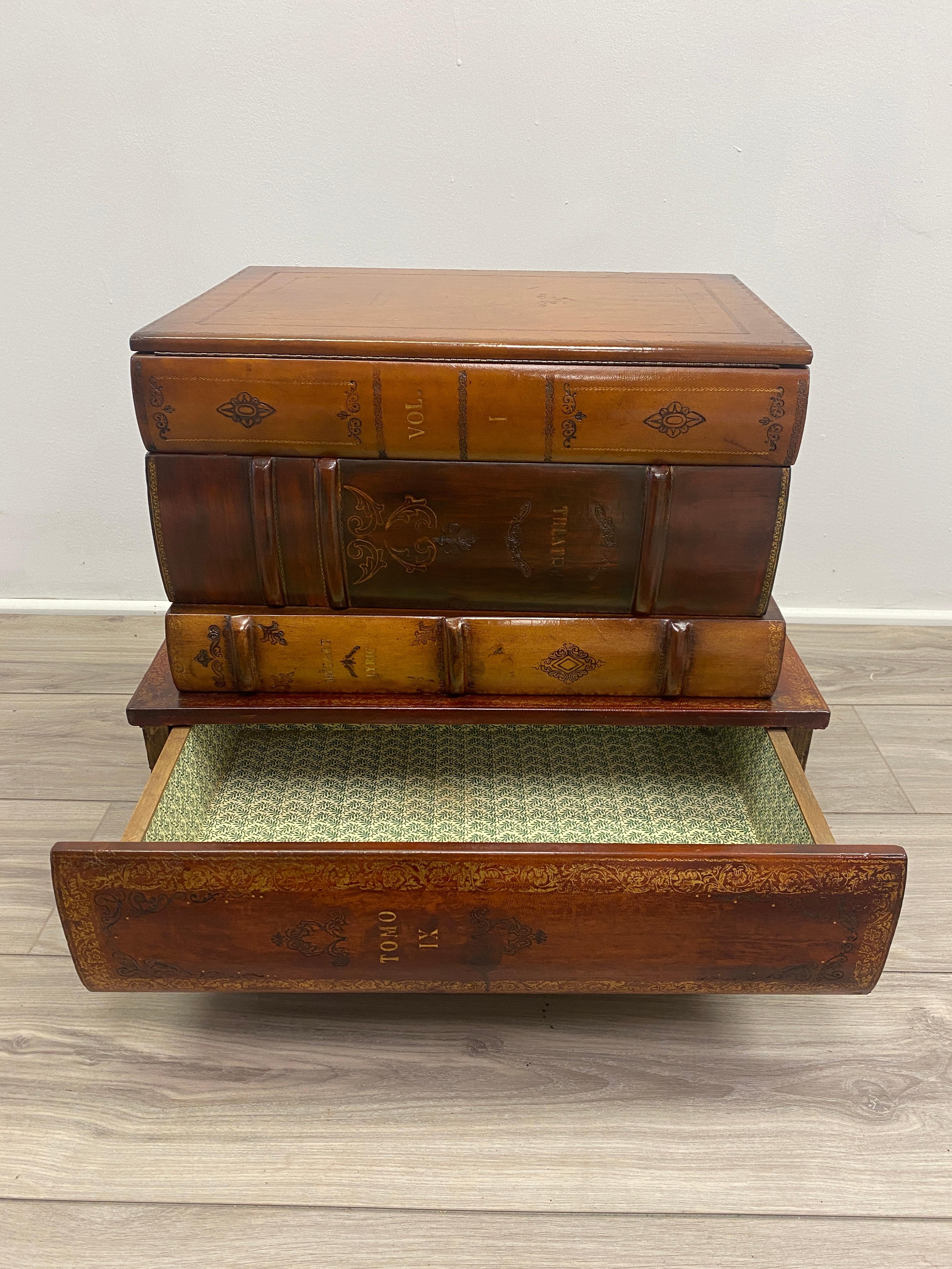 Well made Italian faux stand in book form with tooled leather. Top open to reveal storage, one drawer. Resting on four turned feet. French polished leather.