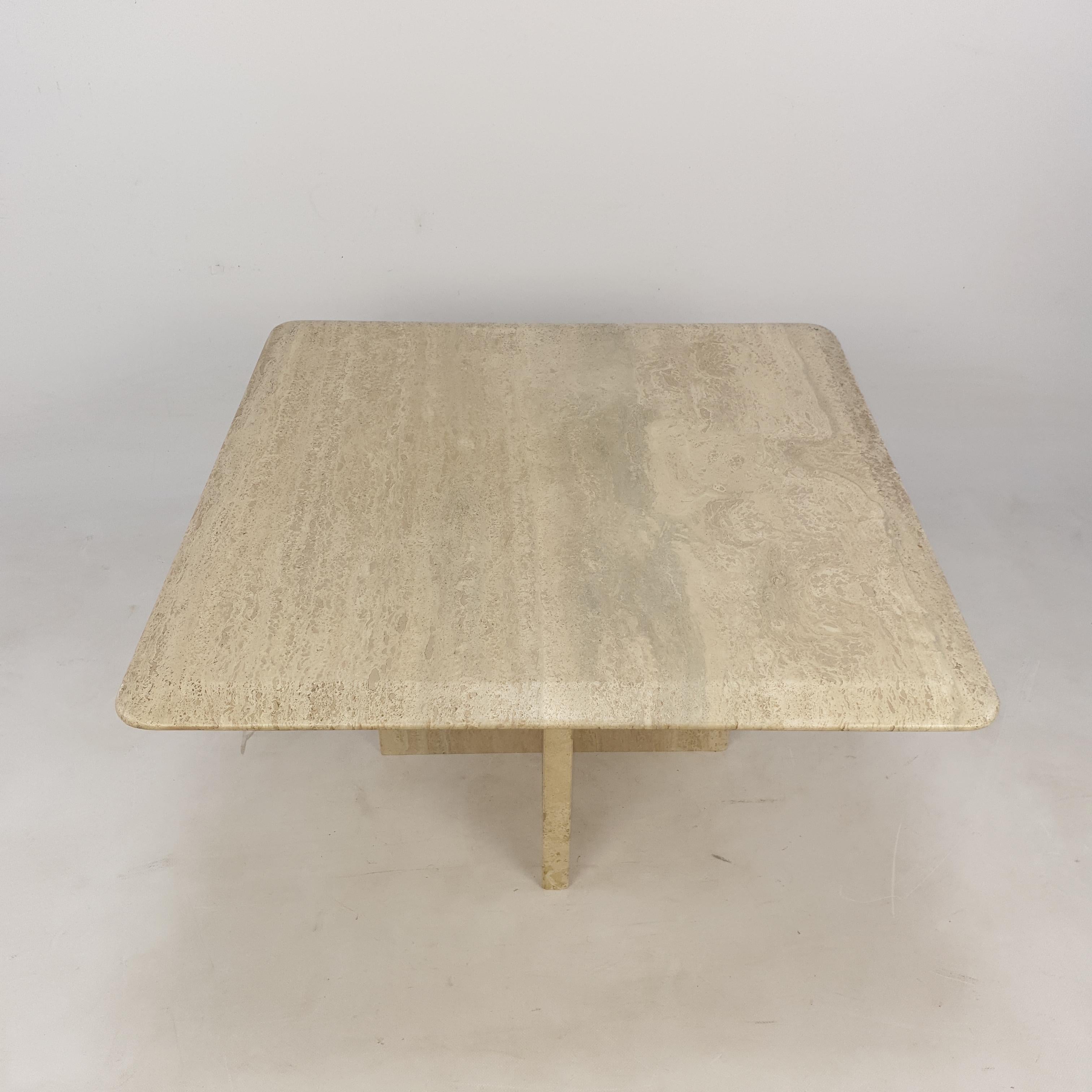 A very nice Italian coffee table of the 80,s, handcrafted out of travertine. The top is rounded on the edge. The base is made of two separate pieces. This vintage marble cocktail table will make the perfect addition to any seating or living room