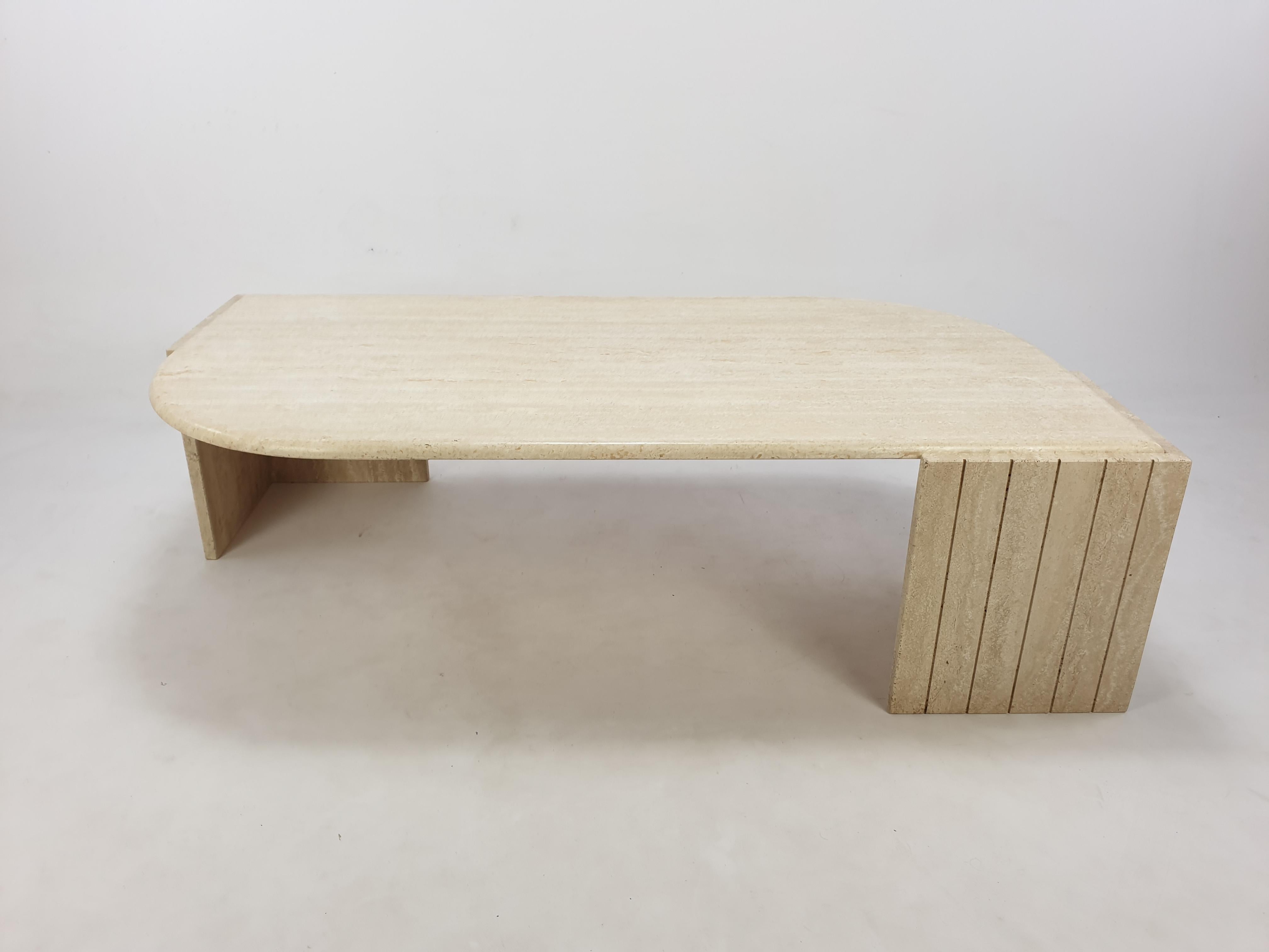 Very elegant Italian coffee table handcrafted out of travertine. 

The beautiful teardrop shaped top is rounded on the edge. 
The base is made of two separate pieces.
    