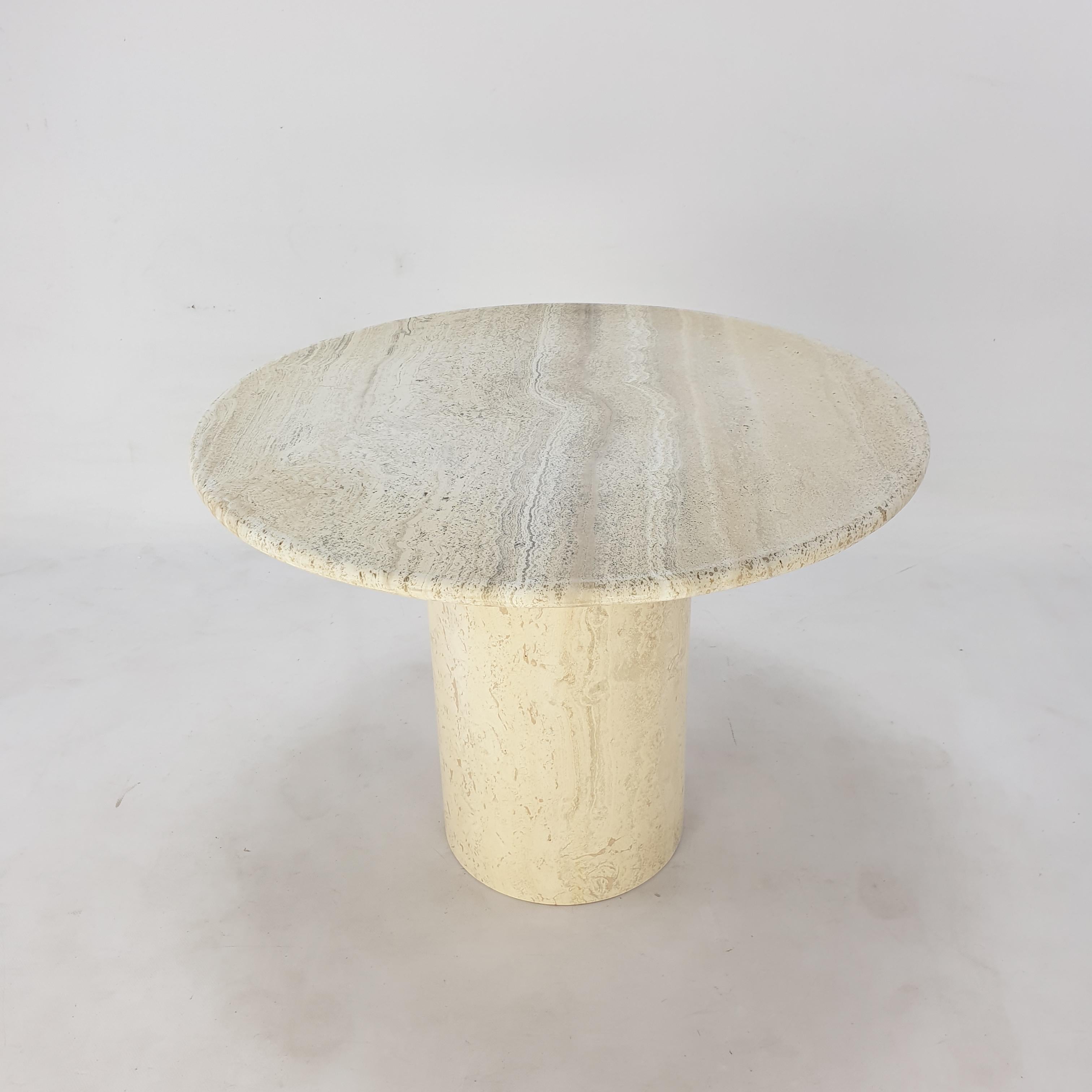 Very nice Italian coffee table handcrafted out of travertine. 

It has a beautiful round top and a round base, they can be separated.

It is fabricated in the early 80's.