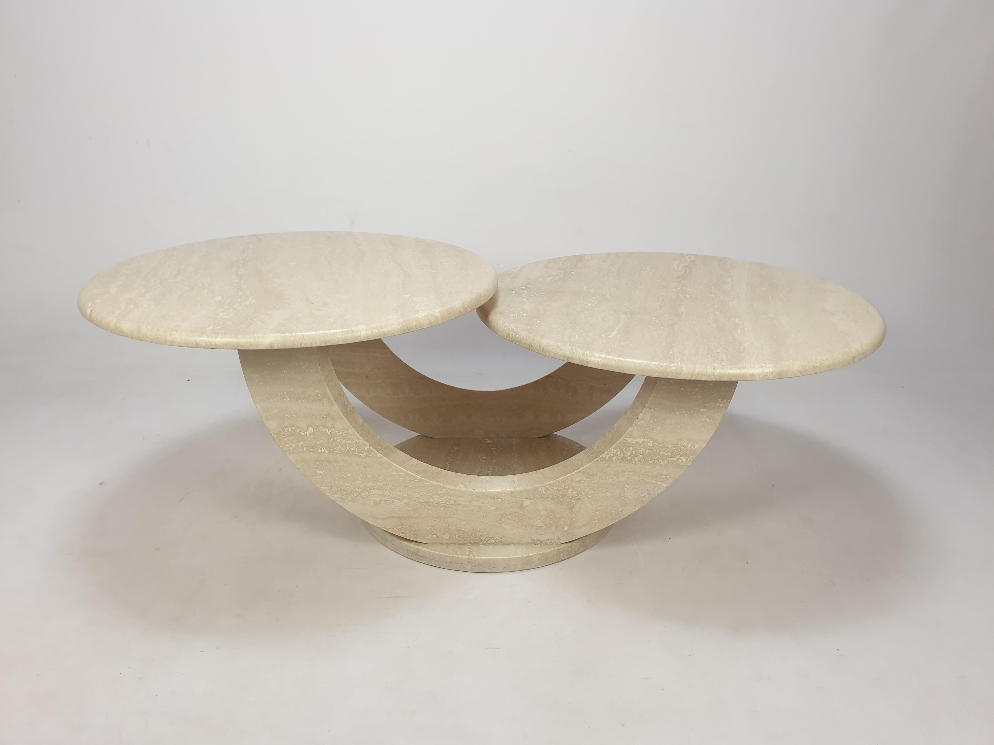 Very nice and rare Italian coffee table, fabricated in the 80's. 

Two round plates on a very elegant base. 
The plates are rounded on the edge. 

This lovely table is made of beautiful travertine.