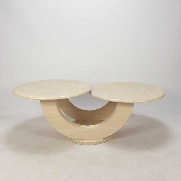 Very nice and rare Italian coffee table, fabricated in the 1980s. 

Two round plates on a very elegant base. 
The plates are rounded on the edge. 

This lovely table is made of beautiful travertine.

The table is in very good condition, just