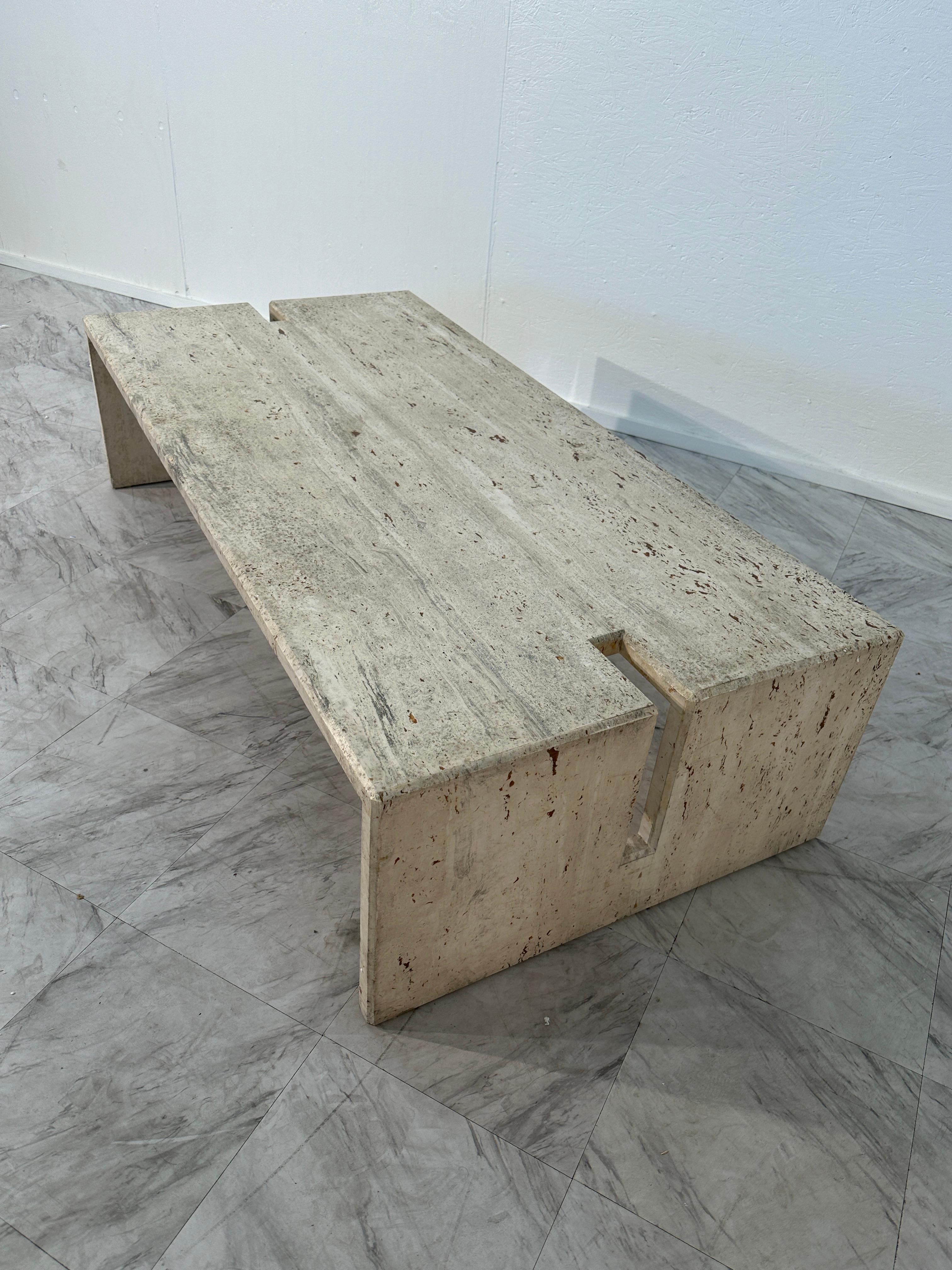 The Mid Century Italian Travertine Coffee Table by Studio A, crafted in the 1970s, is a timeless piece characterized by its fully travertine construction and sleek rectangular shape. The table embodies the distinctive mid-century design aesthetic,
