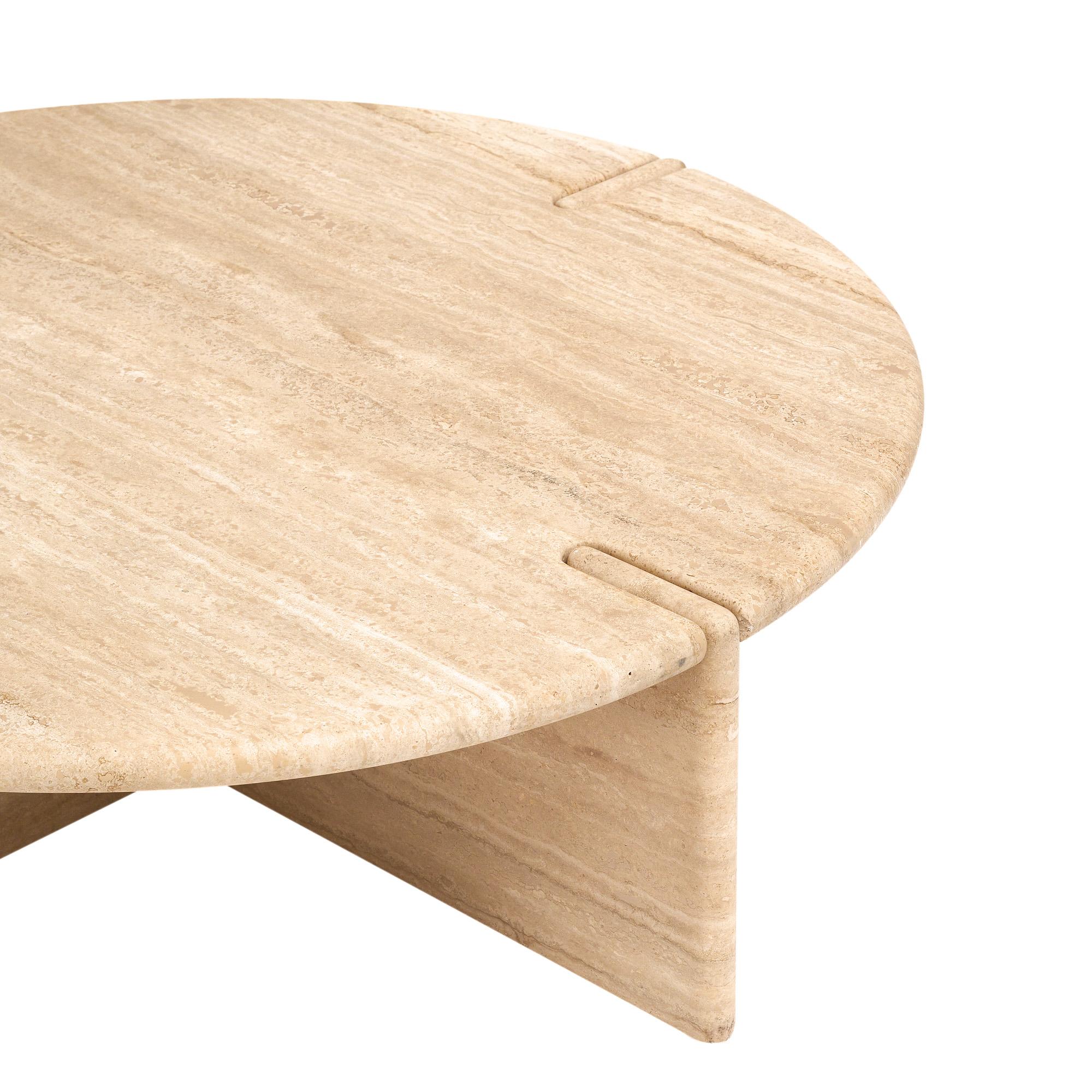 Coffee table from Italy in the mid-century style. This piece is made with a large travertine circular slab that fits atop two overlapping pieces of travertine that form the four legs when combined. It is a superb design that showcases the clean
