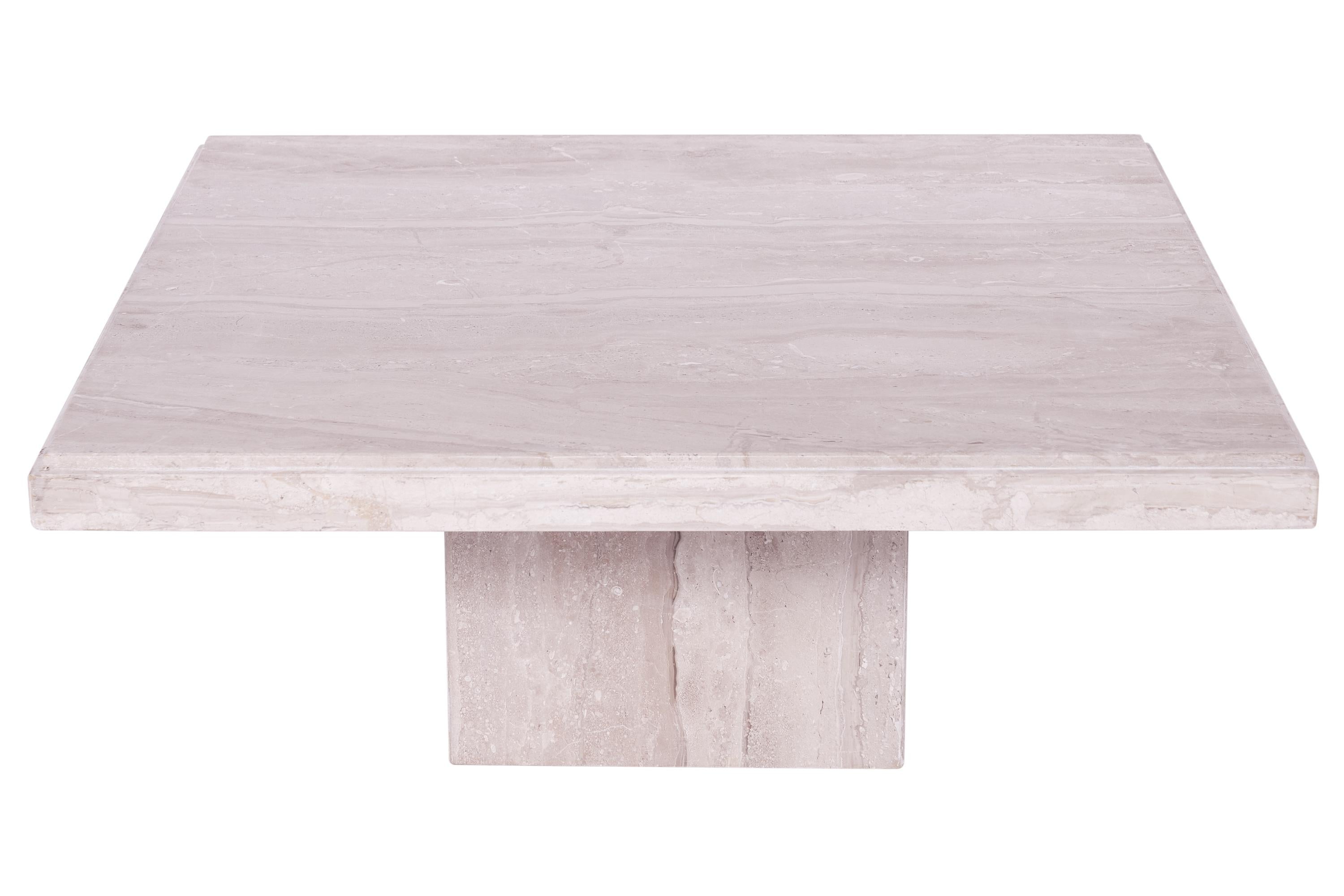 A fabulous stone coffee table crafted out of travertine marble. This table has an eye-catching has a square top with rounded edges and rests on a floating base. This Minimalist coffee marble table would make a great addition to any home or office