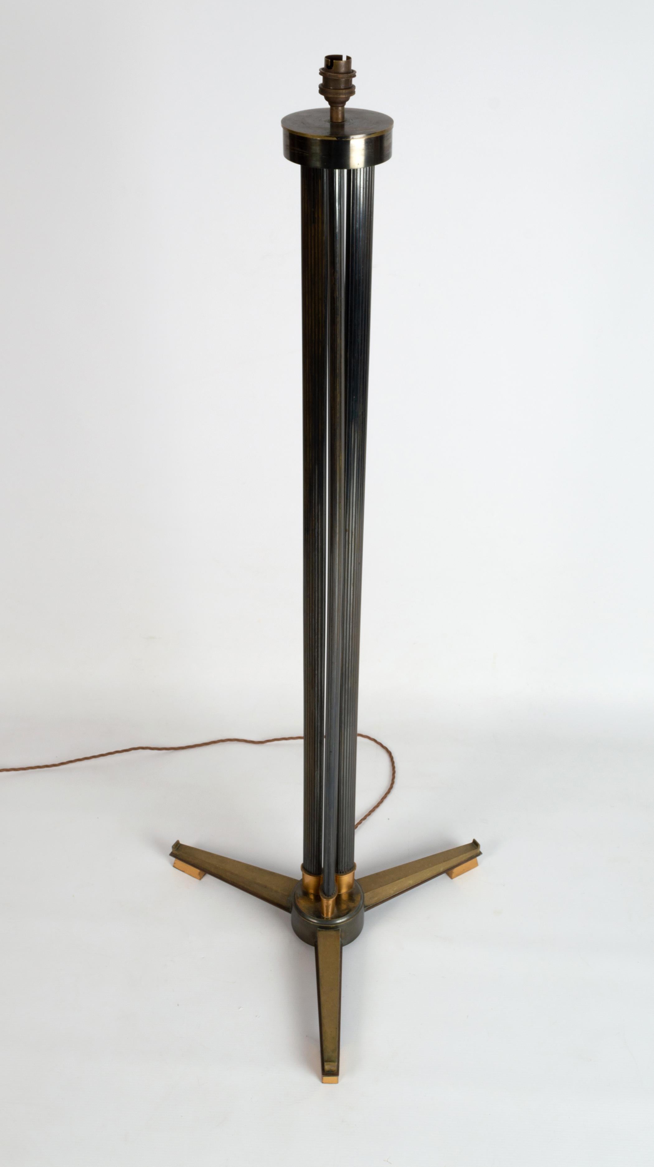 A mid century Italian Triform brass reeded column floor lamp 
Italy, C.1950.