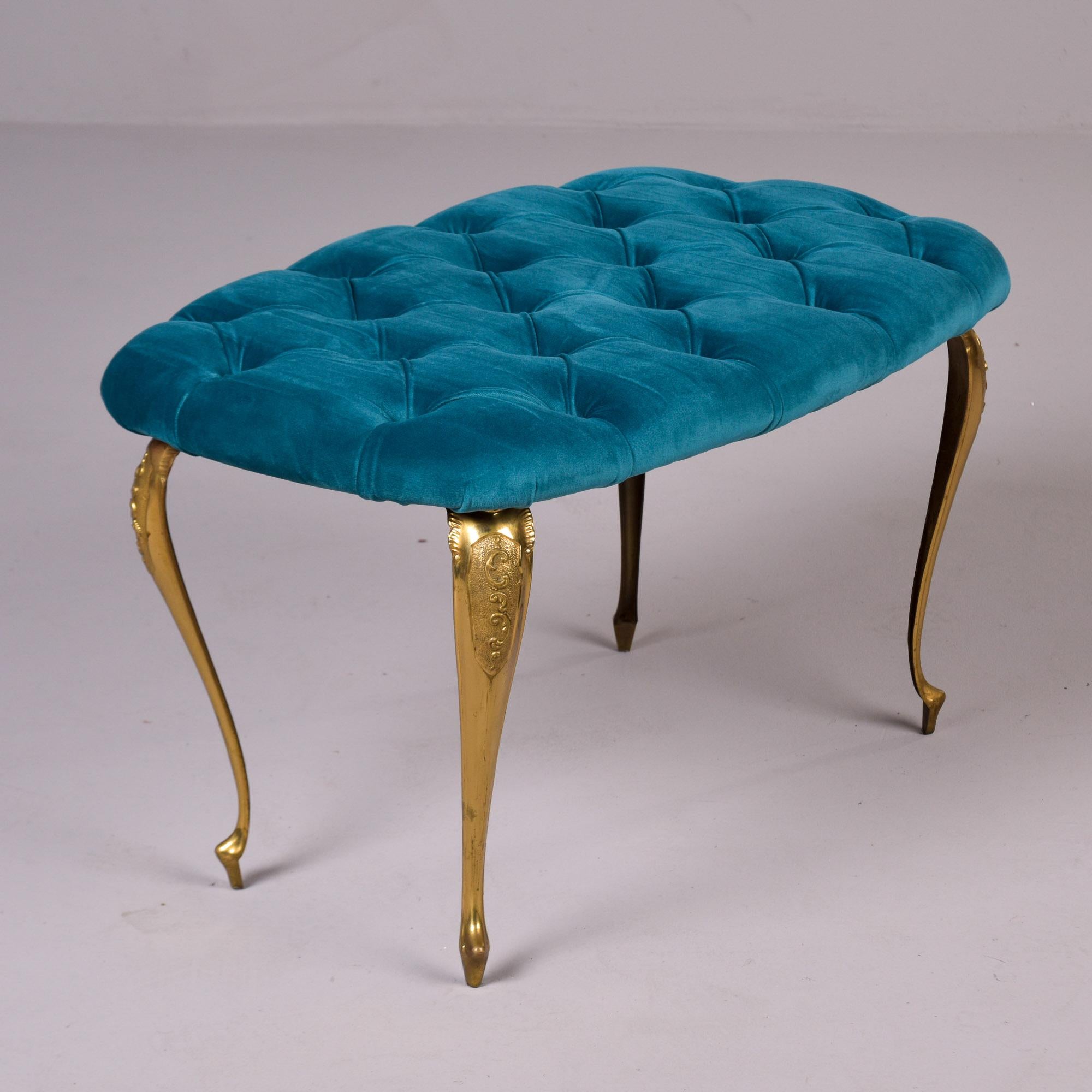 Found in Italy, this upholstered bench dates from the 1940s. The bench features cast brass cabriole legs with decorative detail at the top. Newly upholstered in a teal velvet with button-tufted seat. Unknown maker. 

Very good vintage condition with