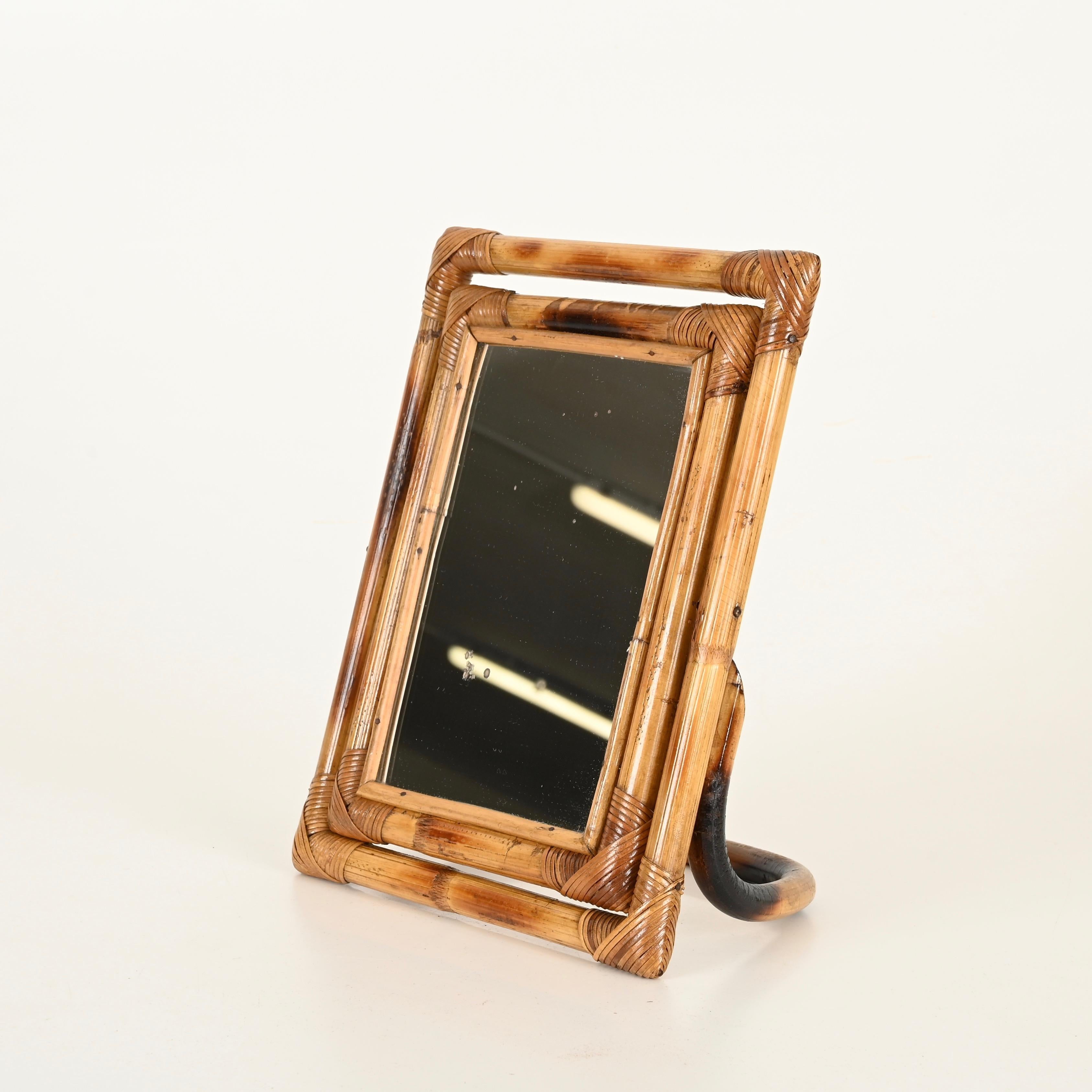 Wonderful Mid-Century adjustable vanity table mirror, crafted in a beautiful combination of curved rattan and hand-woven wicker. This stylish and unique organic piece was designed in Italy during the 1970s.

In great vintage condition, featuring a