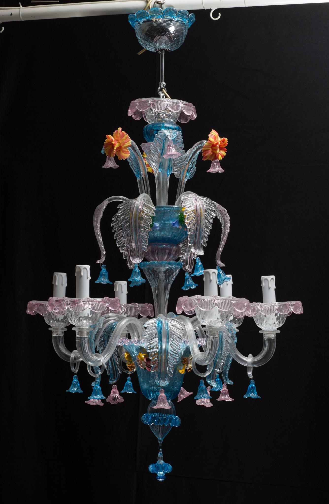 A handcrafted midcentury Italian Murano glass chandelier from Venetia designed by Galliano Ferro.

This colorful light has two levels, and because of that is also called Castelletto which translates to little castle. 
At the first level, you can see