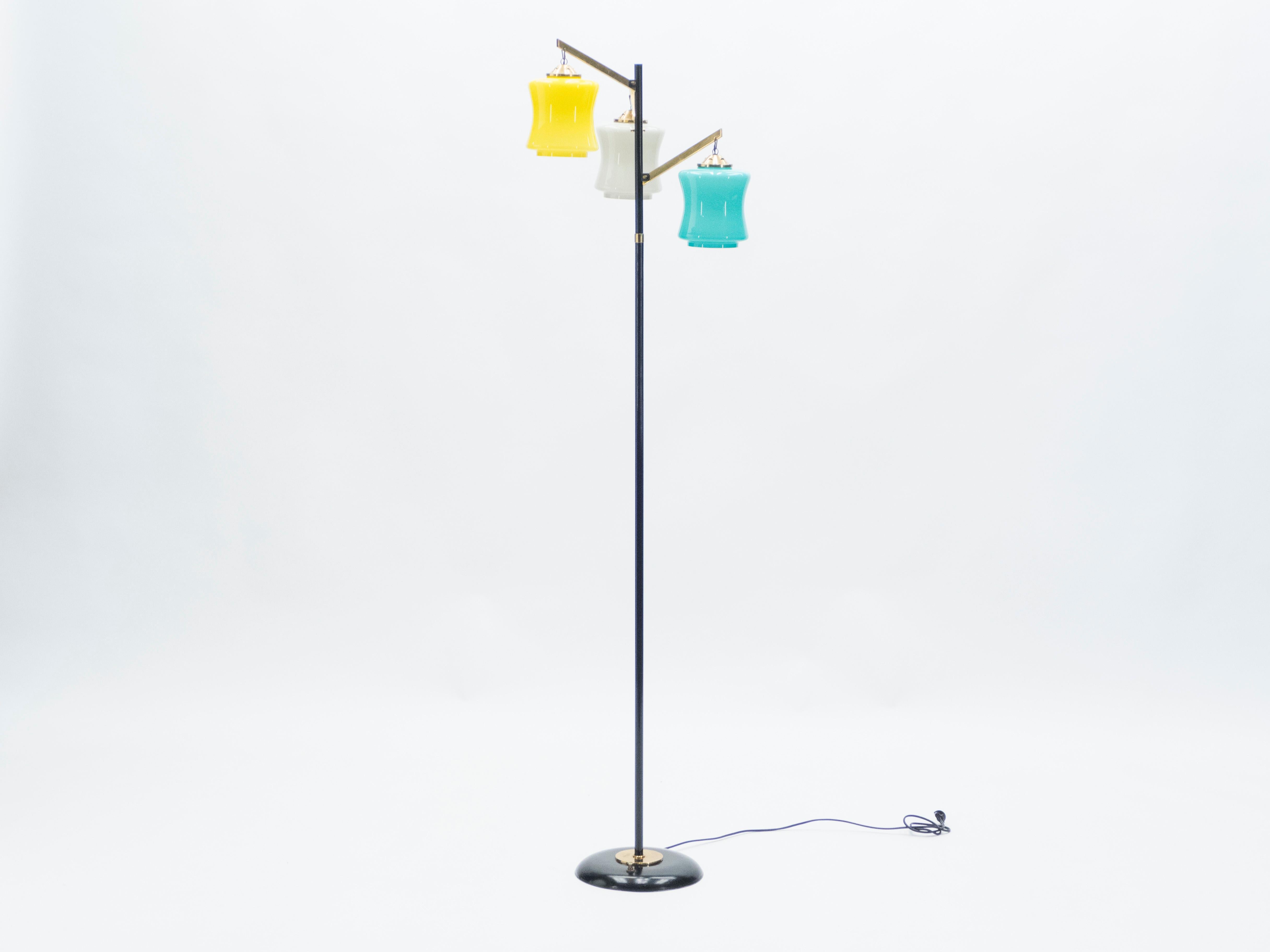 Vintage Italian floor lamp by Vistosi, with three Murano glasses in blue, yellow, and white exterior, mounted on painted black metal legs with brass details and handles produced in the 1950s in Italy. An instantly charming floor lamp, with a chic