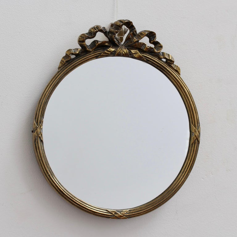 Vintage decorative oval brass mirror with twisted bow, France 1970