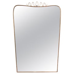 Vintage Midcentury Italian Wall Mirror with Brass Frame and Top Flourish, 
circa 1950s
