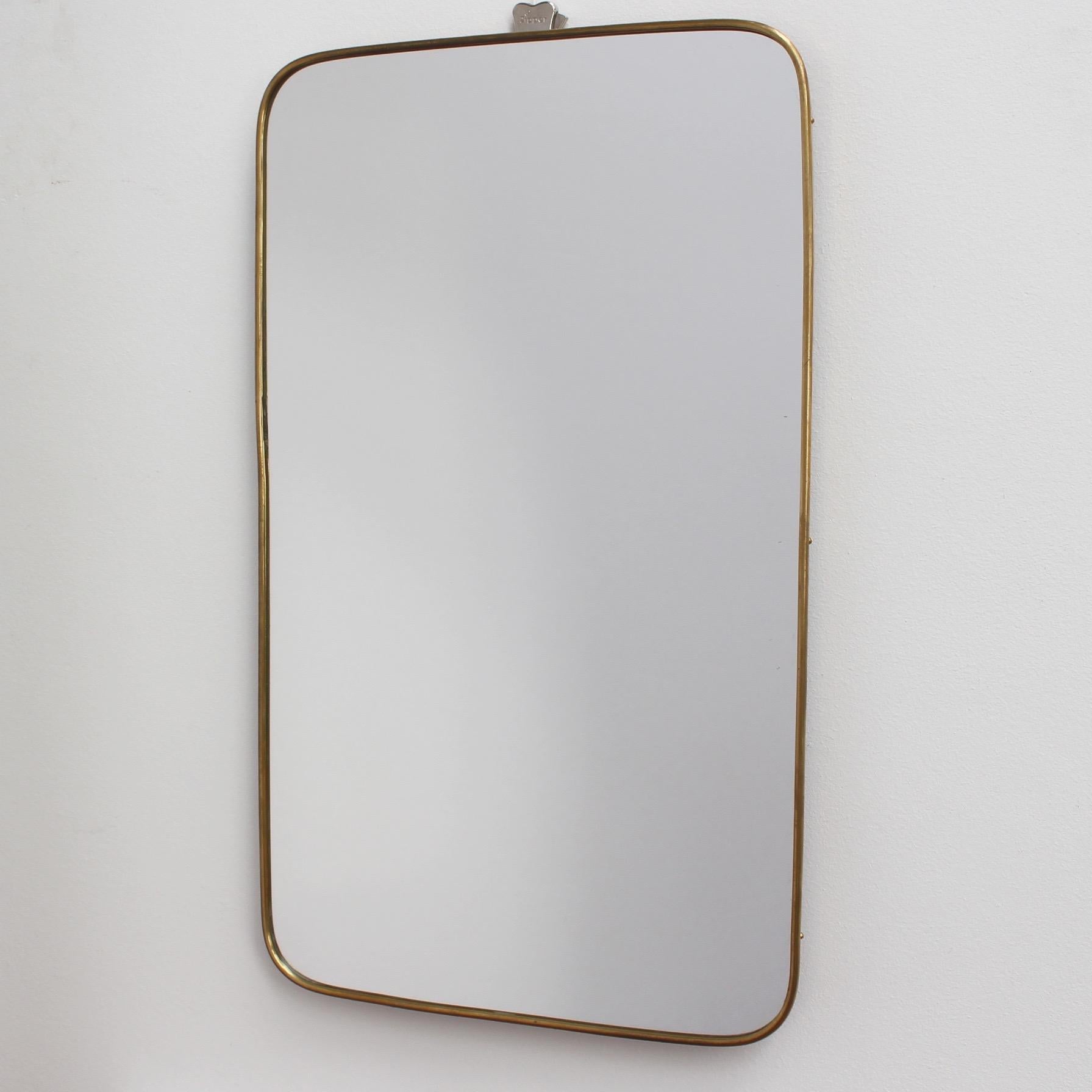 Small-scale midcentury Italian wall mirror with brass frame (circa 1950s). The mirror is rectangular with curved edges and has fittings installed to allow both vertical and horizontal hanging. It is classically elegant and distinctive in a modern