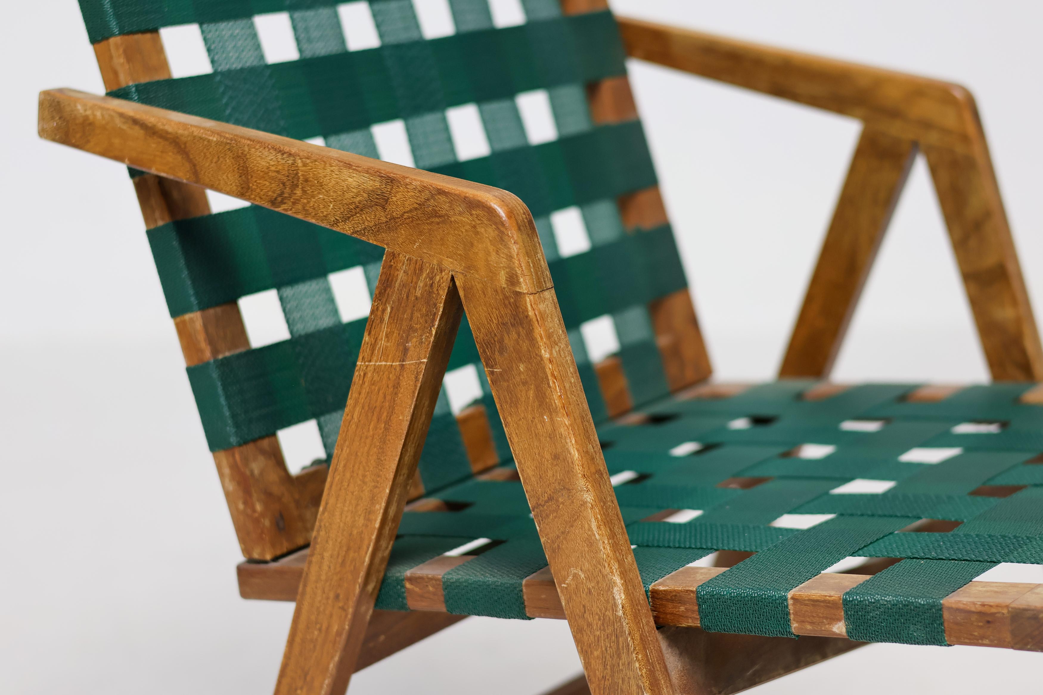 An elegant mid-century modern dining armchair crafted in Italy, featuring a refined walnut frame and original woven webbing to the seat and back. Echoing the spirit of Franco Albini’s celebrated designs, this piece combines architectural lines with
