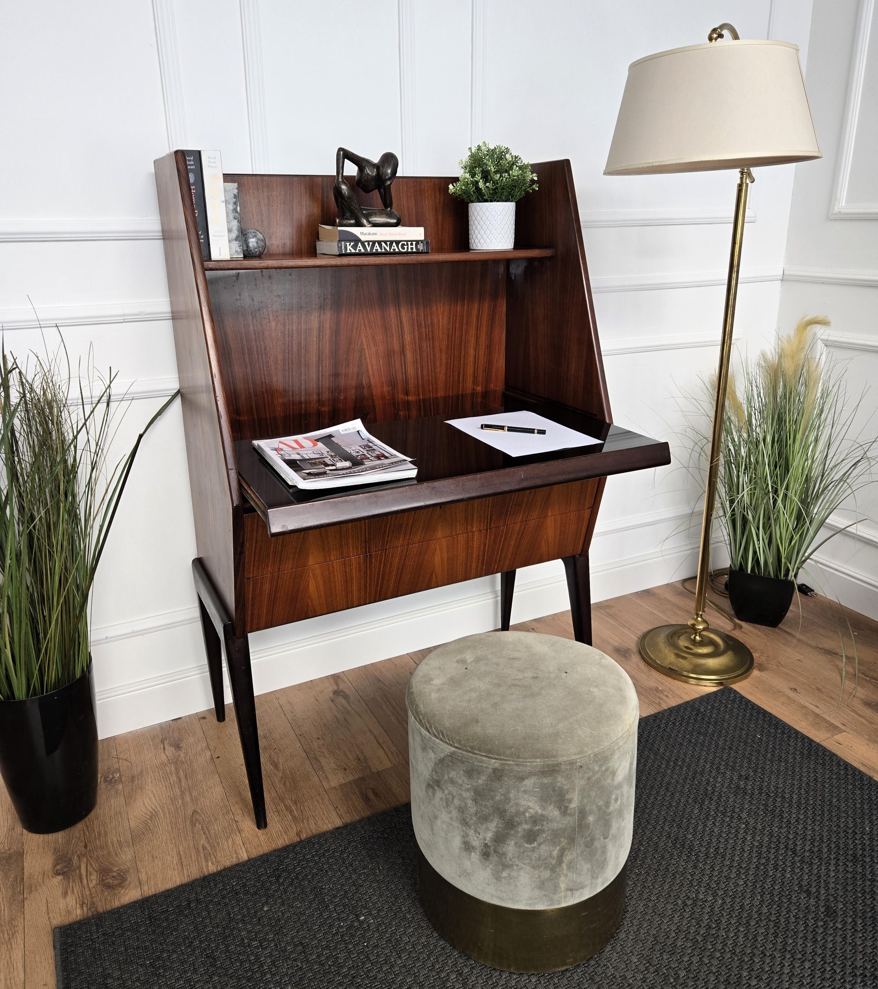 Very elegant and classic Mid-Century Modern Italian walnut wood desk console, writing table, secretary with sliding top with black glass for a seated position when extended, a top shelf and 2 front drawers under the sliding part. This desk will