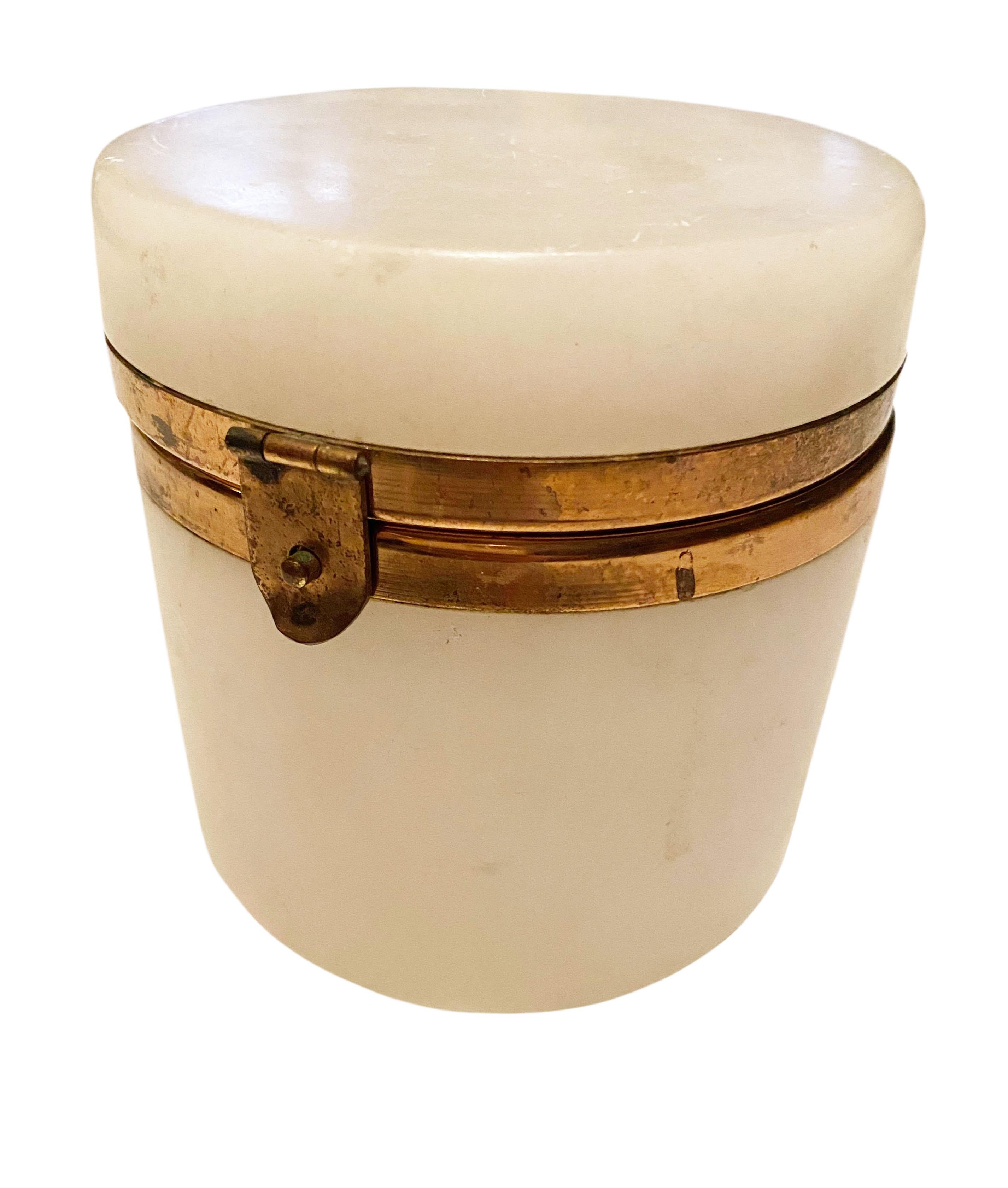 An Italian round mid century white alabaster box. With brass rim and clasp.