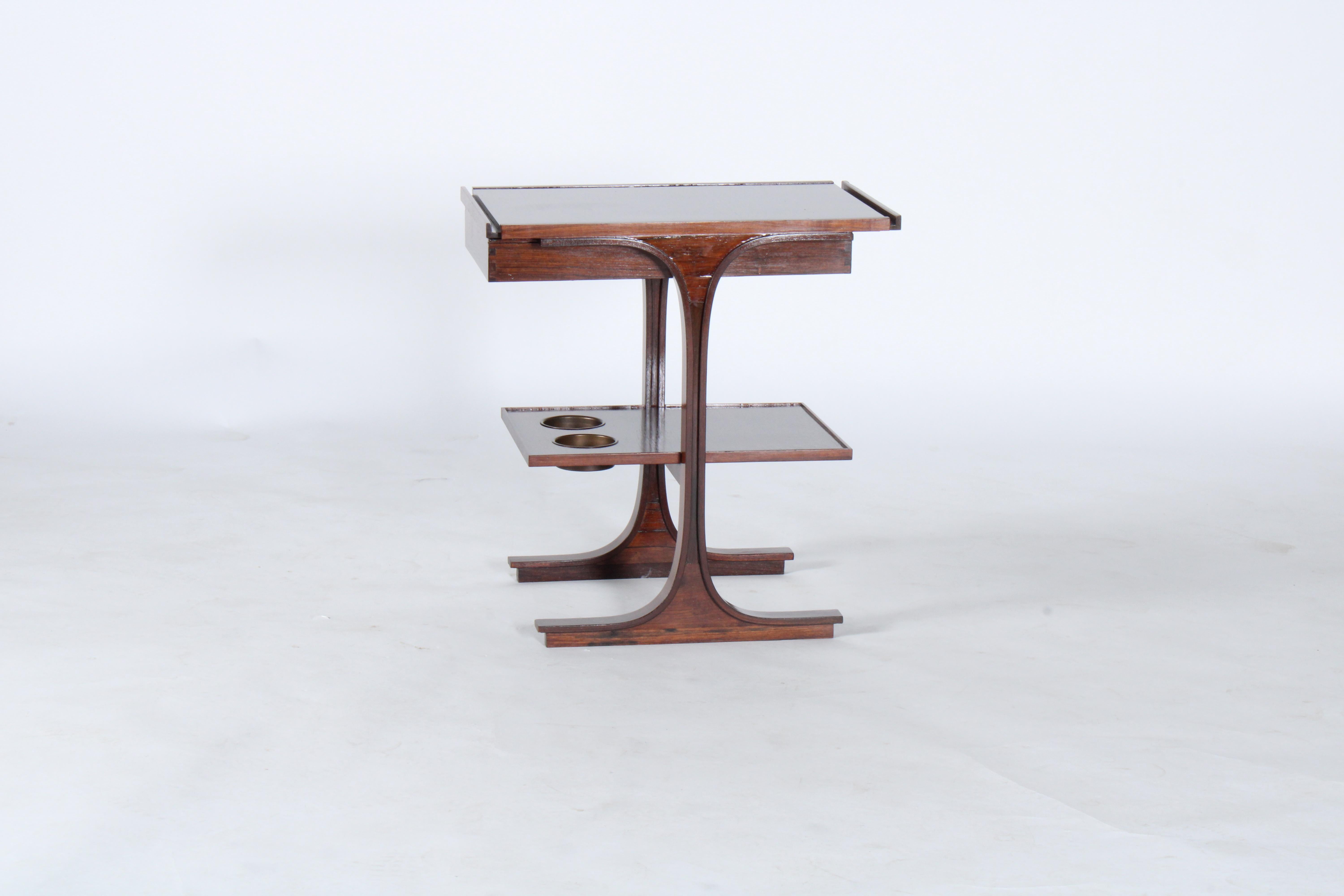 A beautiful, stylish and functional wine table by Gianfranco Frattini for Bernini. Designed and made circa 1963 this gorgeous piece with stunning grain pattern offers drawer storage and also inset brass bottle holders for your wine bottles and