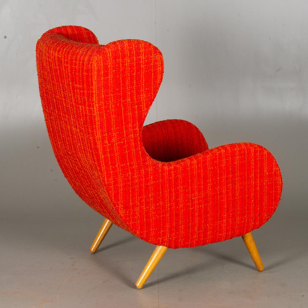 Wingback armchair, wood frame with an original upholstery with a red fabric.
New upholstery on request possible.