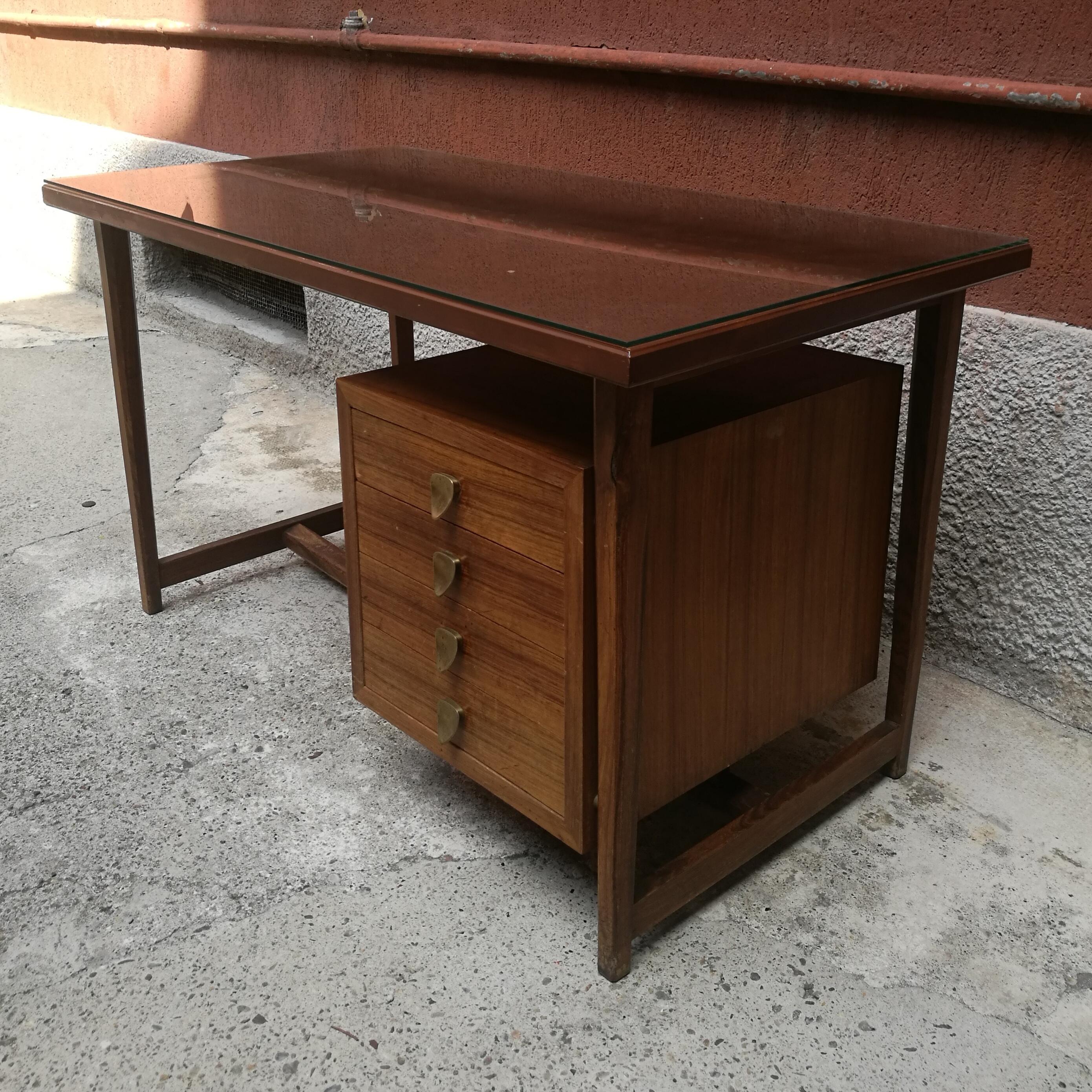 Midcentury Italian, wood and brass desk with glass top, 1960s
Desk with chest of drawers, shaped brass handles and leather top and transparent glass above
A very high quality and rare executive desk.