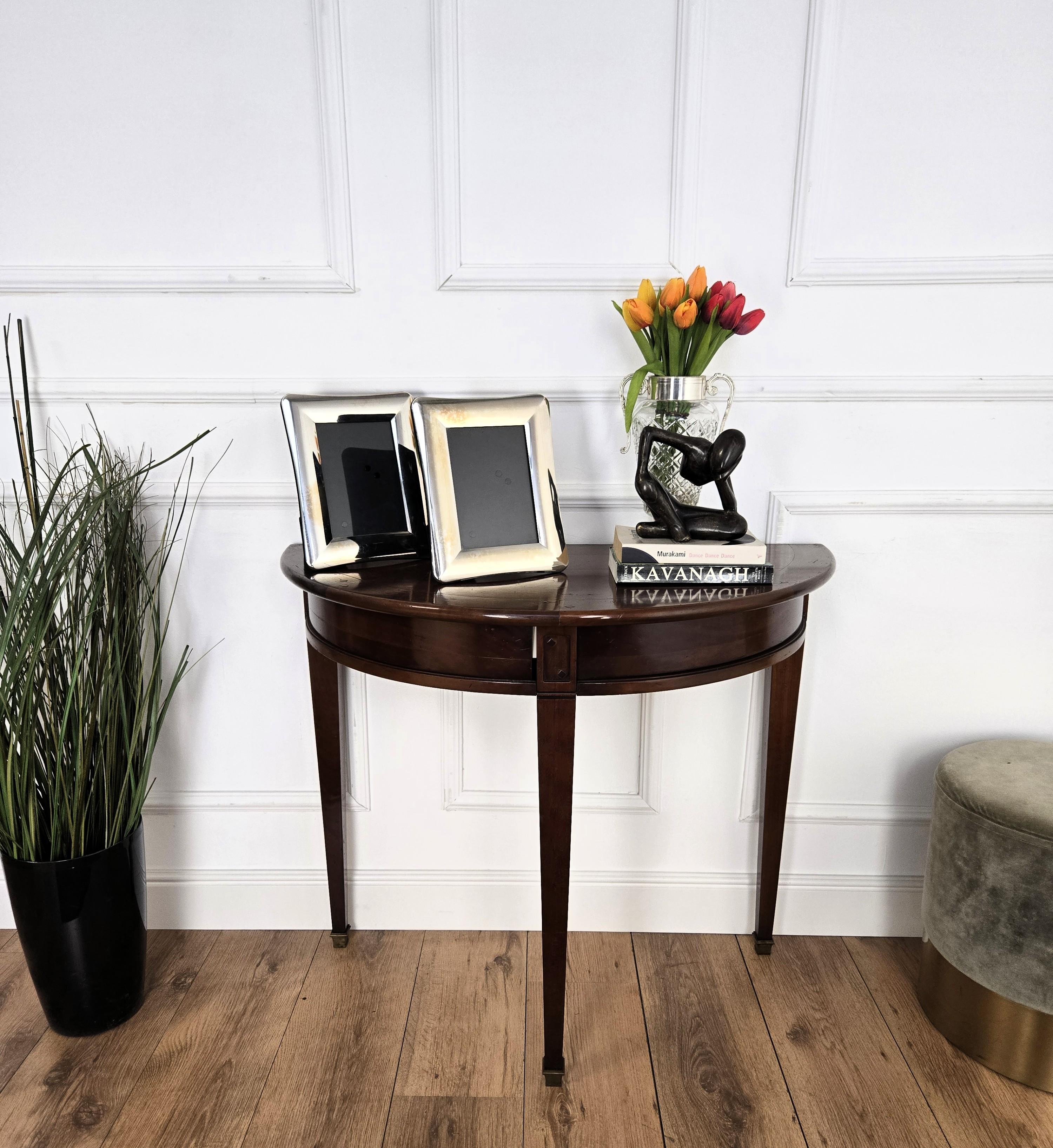 Very elegant and refined Italian Mid-Century Modern design console side table. Standing on three typically carved wooden legs with the classic demi lune shape and top, this console has an extremely light and open aesthetics. It features two hidden