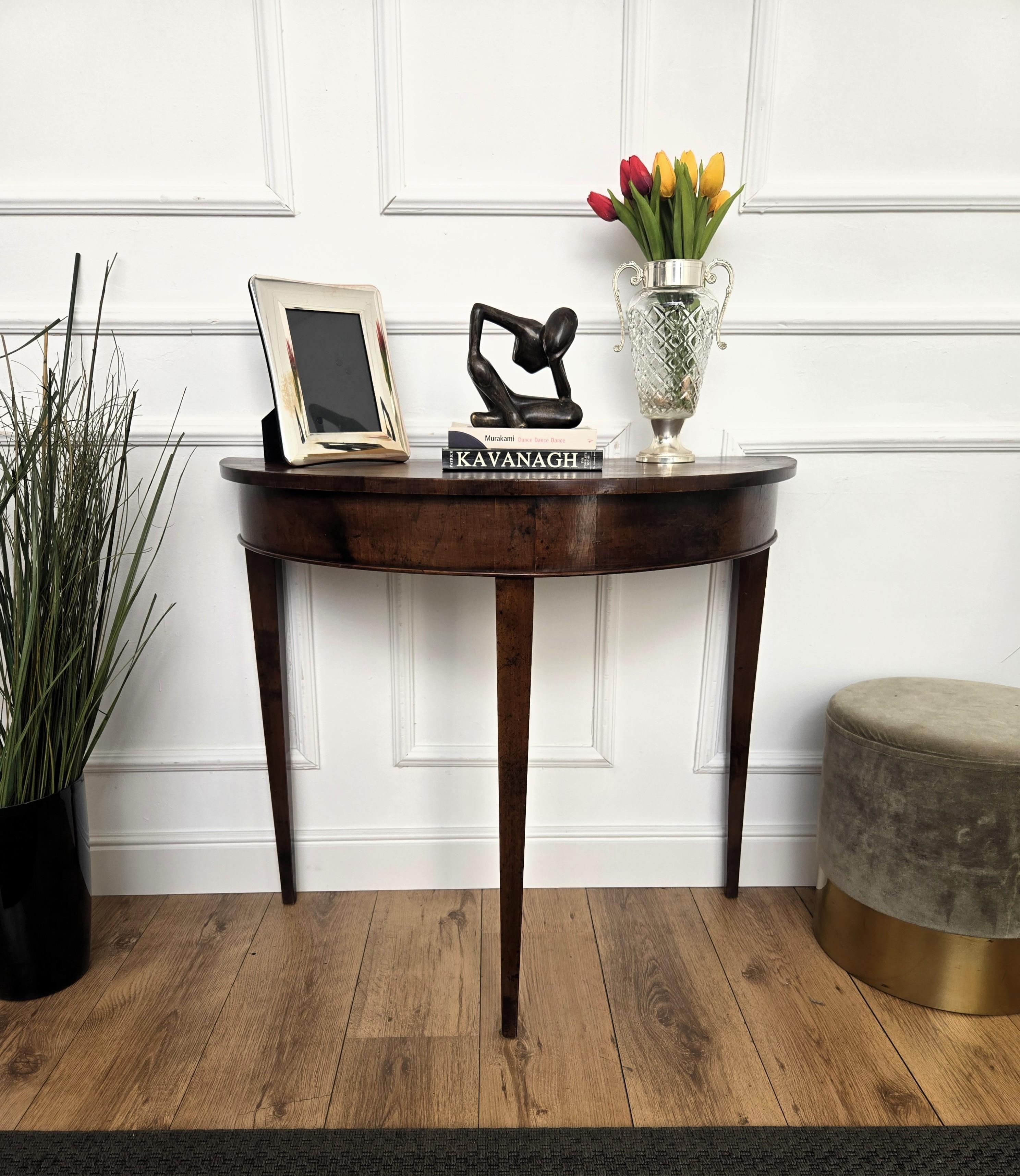 Very elegant and refined Italian Mid-Century Modern design console side table. Standing on three typically shaped wooden legs with the top decorated by the wooden vein veneer inlay, this console has an extremely light and open aesthetics.