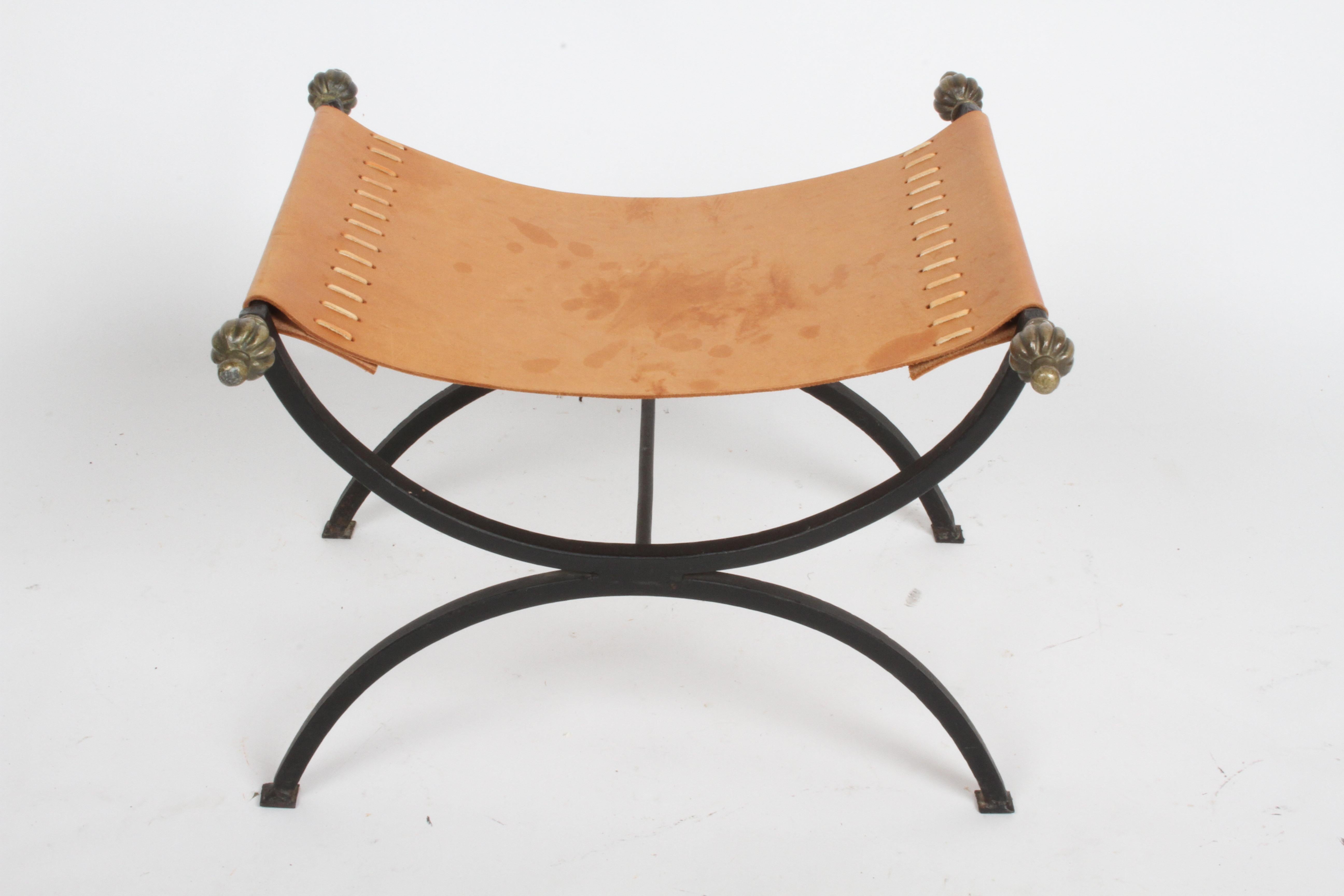 Wonderful Mid-Century Italian Savonarola bench, made of wrought iron with natural leather seat and bronze finials. Hand stitched leather strapping to seat. Natural tan leather seat shows patina, otherwise no issues. Seat is 12.88
