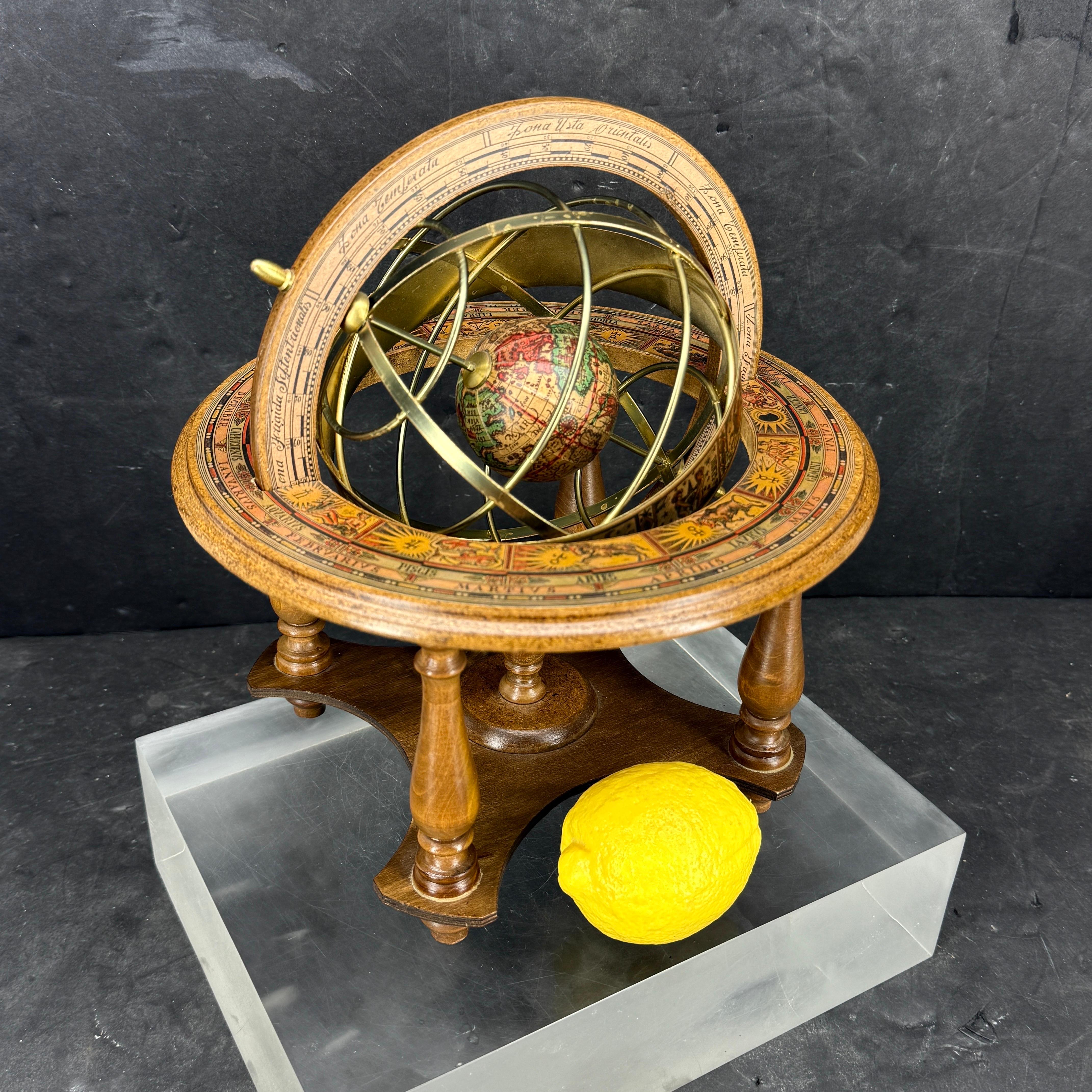 Mid-Size Tabletop Vintage Wooden Spinning Globe, Italy. Charming hand-crafted Mid-Century Modern spinning tabletop globe featuring an antique design world map as well as zodiac symbols.  The globe is beautifully crafted with exquisite detailing
