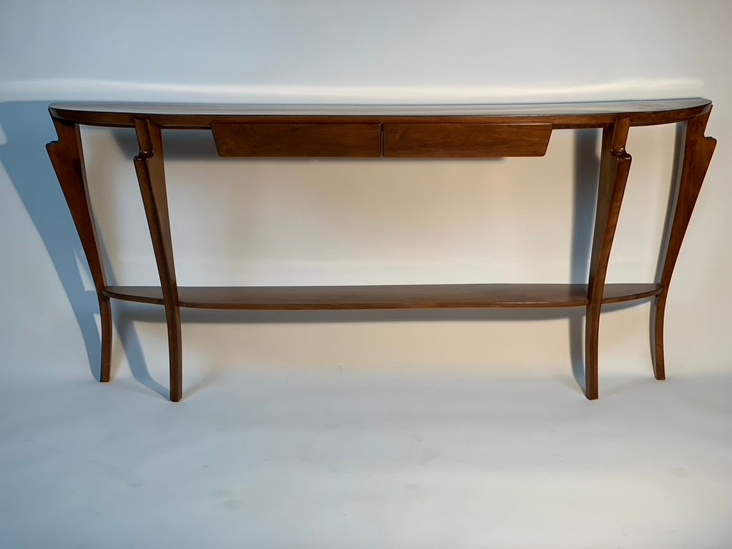 This large half-moon console with two drawers and shelf in the lower part, designed for an apartment projected by Italo Gamberini and made in walnut in Florence Italy in the mid century modern period.
Long and narrow, it has truly elegant