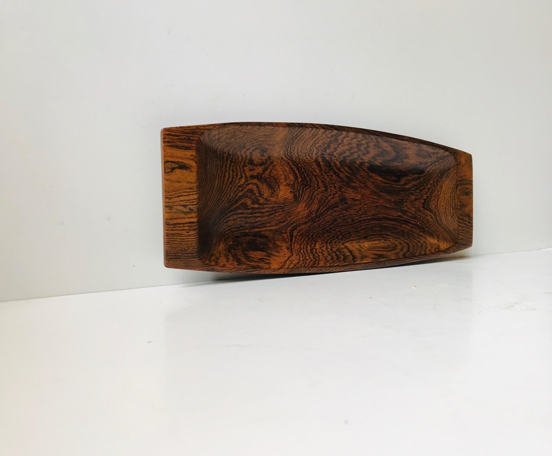 A rare platter or tray carved from a solid piece of Brazilian jacaranda. It was designed during the 1950s by Jean Gillon and manufactured by WoodArt for Georg Jensen in Denmark. These pieces were sold in Illums Bolighus and 'Den Permanente' in