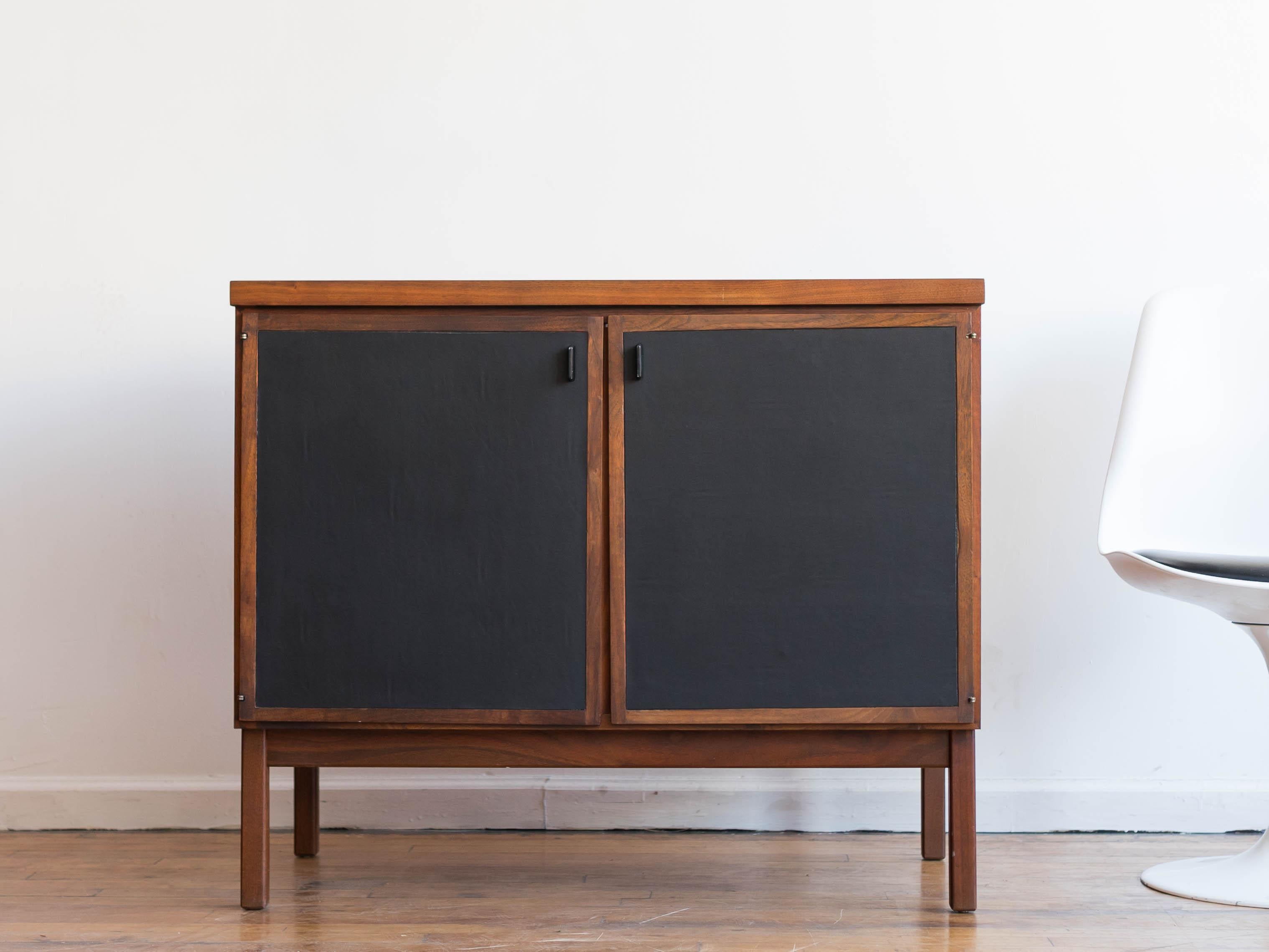 Please inquire about discounted local/regional delivery 

36” x 18” x 30.5”H

Versatile two door cabinet designed by Jack Cartwright for Founders Furniture. 
•faux leather upholstery on the doors
•Founders' signature black metal finger pulls
•one