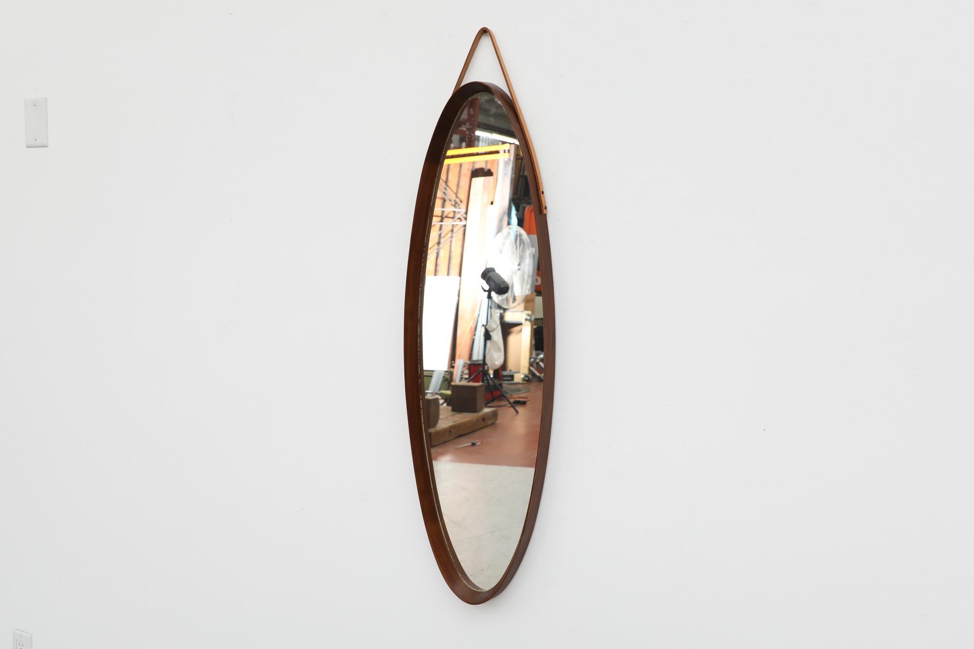 Mid-20th Century Mid-Century Jacques Adnet Inspired Oval Italian Teak Mirror with Leather Strap For Sale