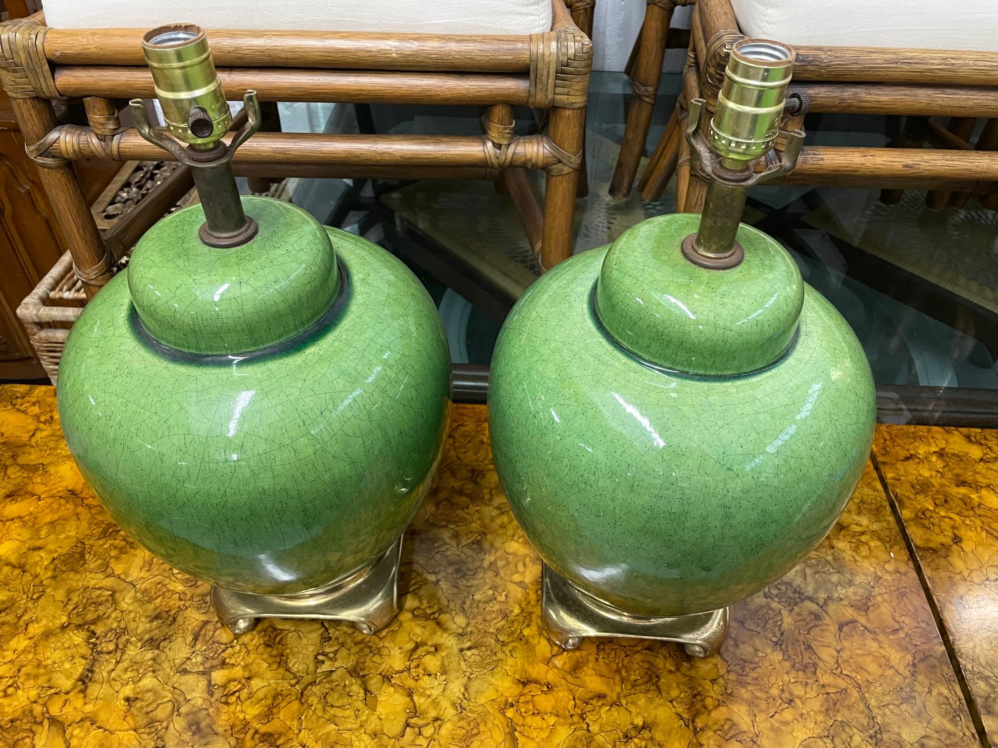 Pair of mid-century ceramic ginger jar table lamps by Nathan Lagin feature brass bases and a beautiful jade finish. Very good condition with only minor imperfections consistent with age. Shades not included.