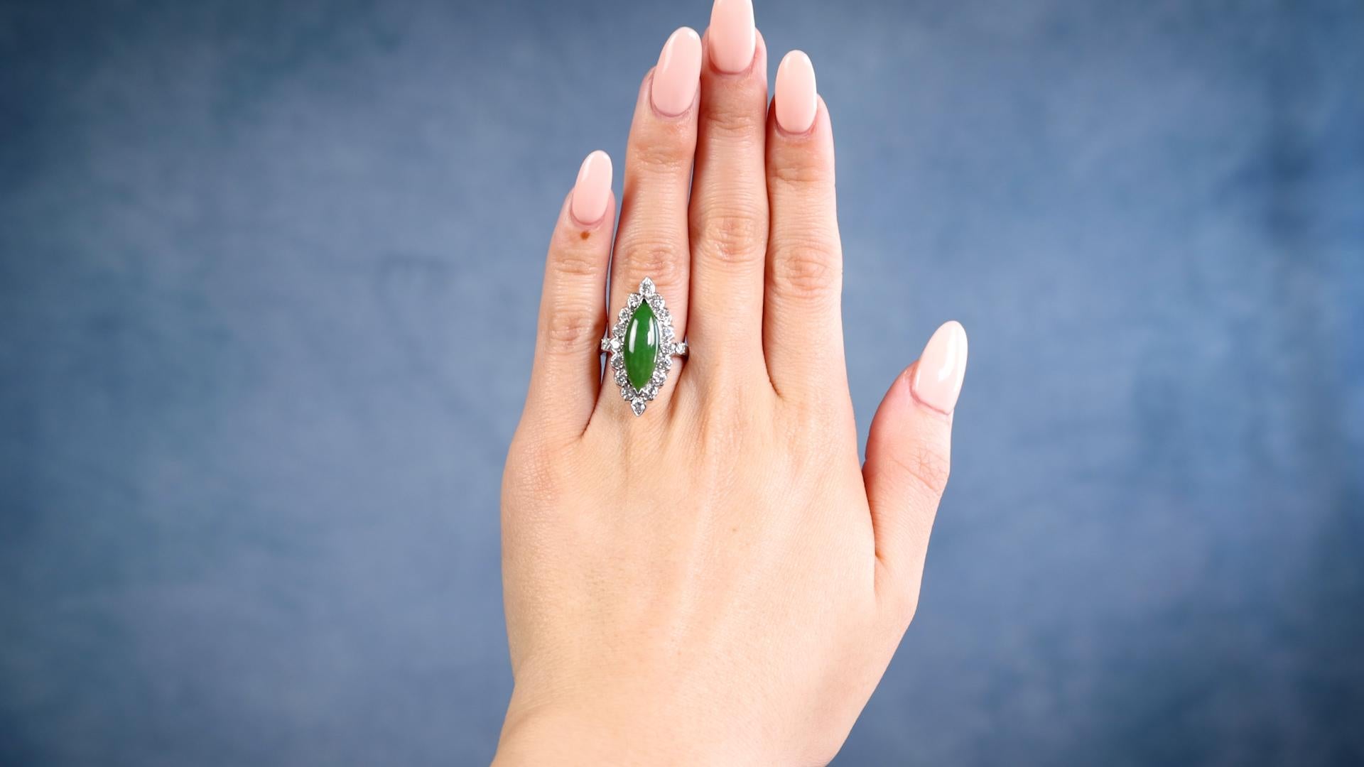 One Mid-Century Jadeite Diamond 14k White Gold Navette Ring. Featuring one cabochon cut marquise jadeite weighing approximately 2.50 carats. Accented by 18 round brilliant and old European cut diamonds with a total weight of approximately 1.20