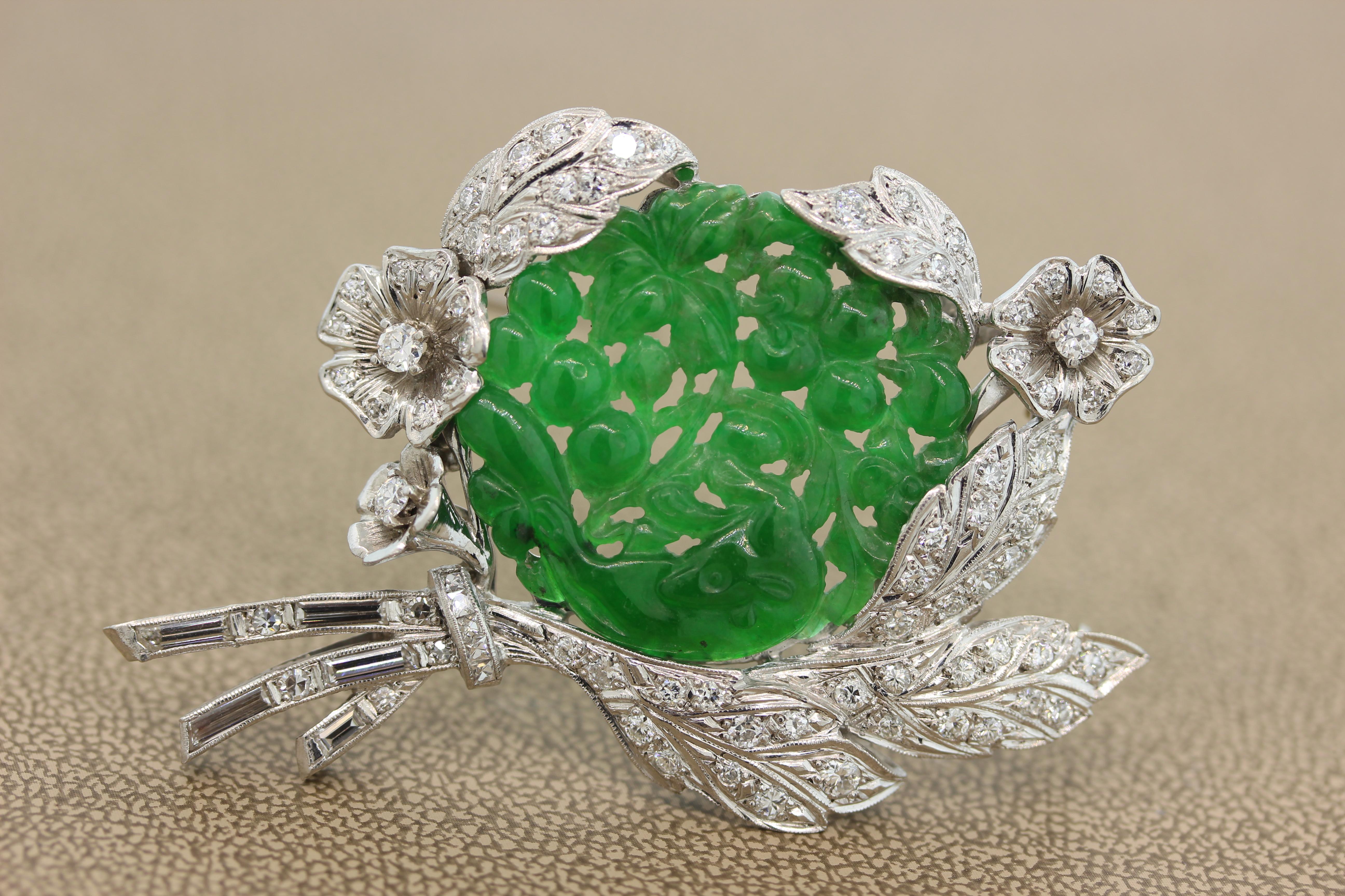 A magnificent Mid-Century convertible brooch that doubles as a pendant. A lustrous translucent piece of carved jade depicts an animal amidst a flower garden. The carved jade is set in platinum with approximately 2.40 carats of round and baguette