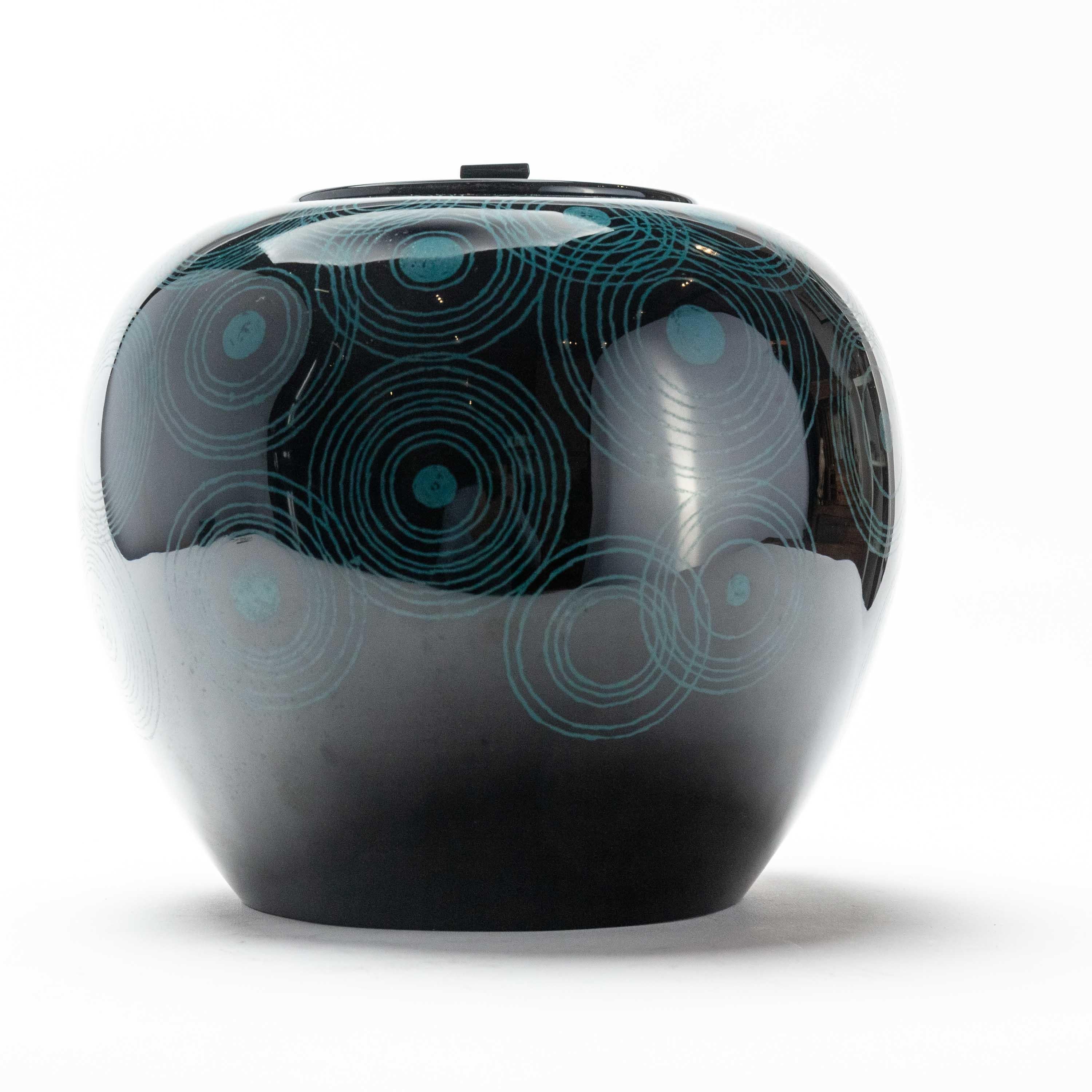A stunning and curvaceous black lacquer mizusashi from Japan. Mizusashi are used in Japanese tea ceremony, as water containers. They are one of the main aesthetic components for a host to consider. This one features a stylish concentric circle
