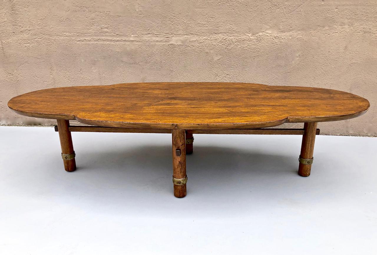 This is a unique Japanese cloud-form low table that dates to the mid-20th century. The single plank solid black walnut top is shaped in the form of a traditional Japanese representation of a cloud. The simple solid wood tubular form legs are