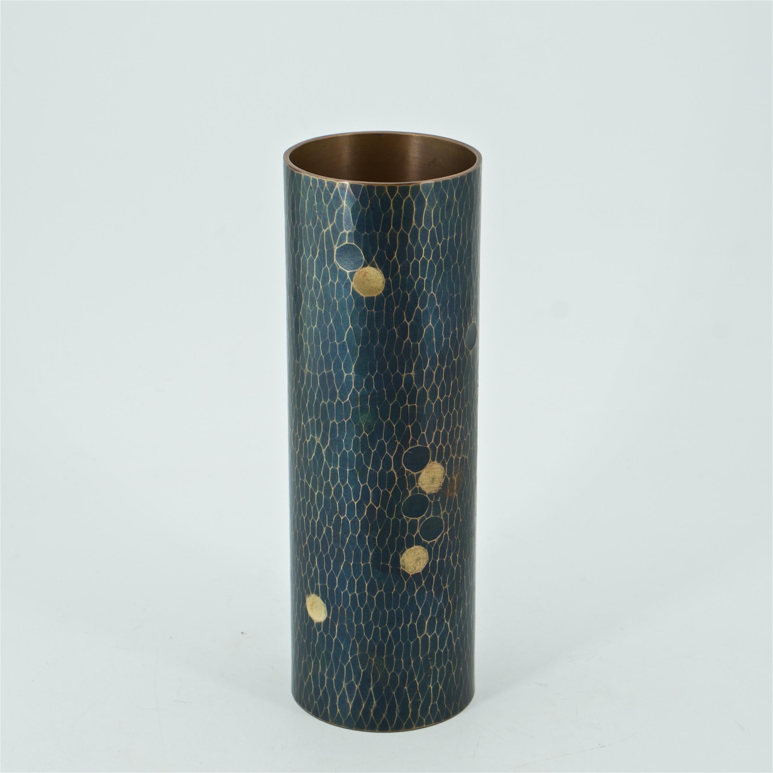 A fine vintage Japanese bronze and brass cylinder vase with a martele finish. Black patinated surface, polished ridges, and brass inlaid dots. Impressed maker’s mark on verso.
- Item Weight  590g
 